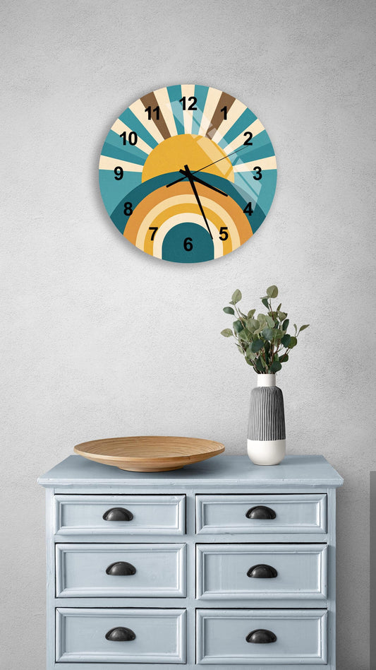 a wall clock with a sun-like design, mounted on a wall above a light blue dresser with six drawers. The dresser also has a vase with greenery and a wooden tray on top.