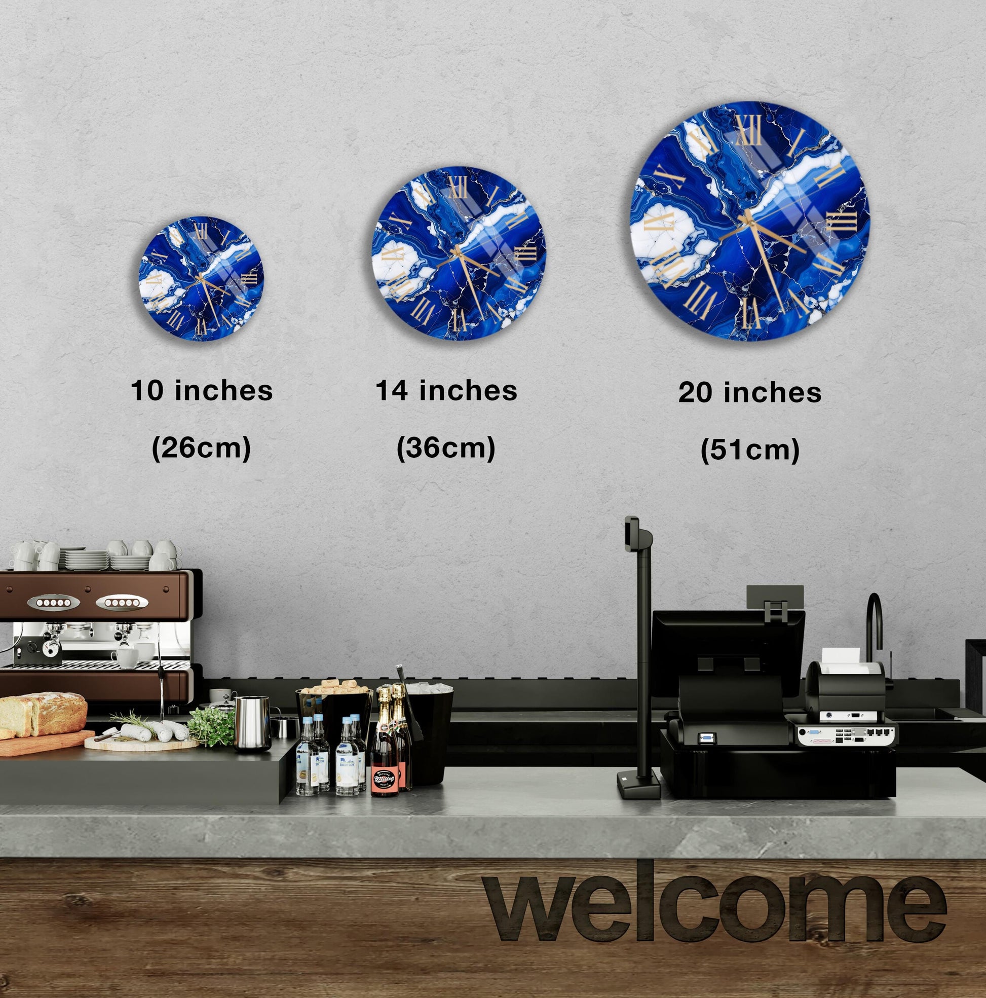 a wall with three clock designs, each representing a different size: 10 inches, 14 inches, and 20 inches. Below the clocks, there is a counter with various items such as bottles and a cash register. The word "welcome" is also visible in the image.