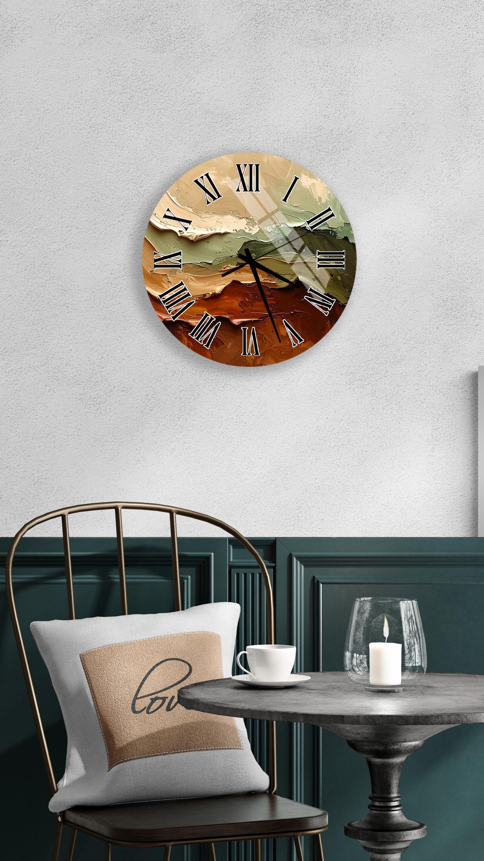 a wall clock with a landscape design, a table with a candle and a cup, and a chair with a pillow.