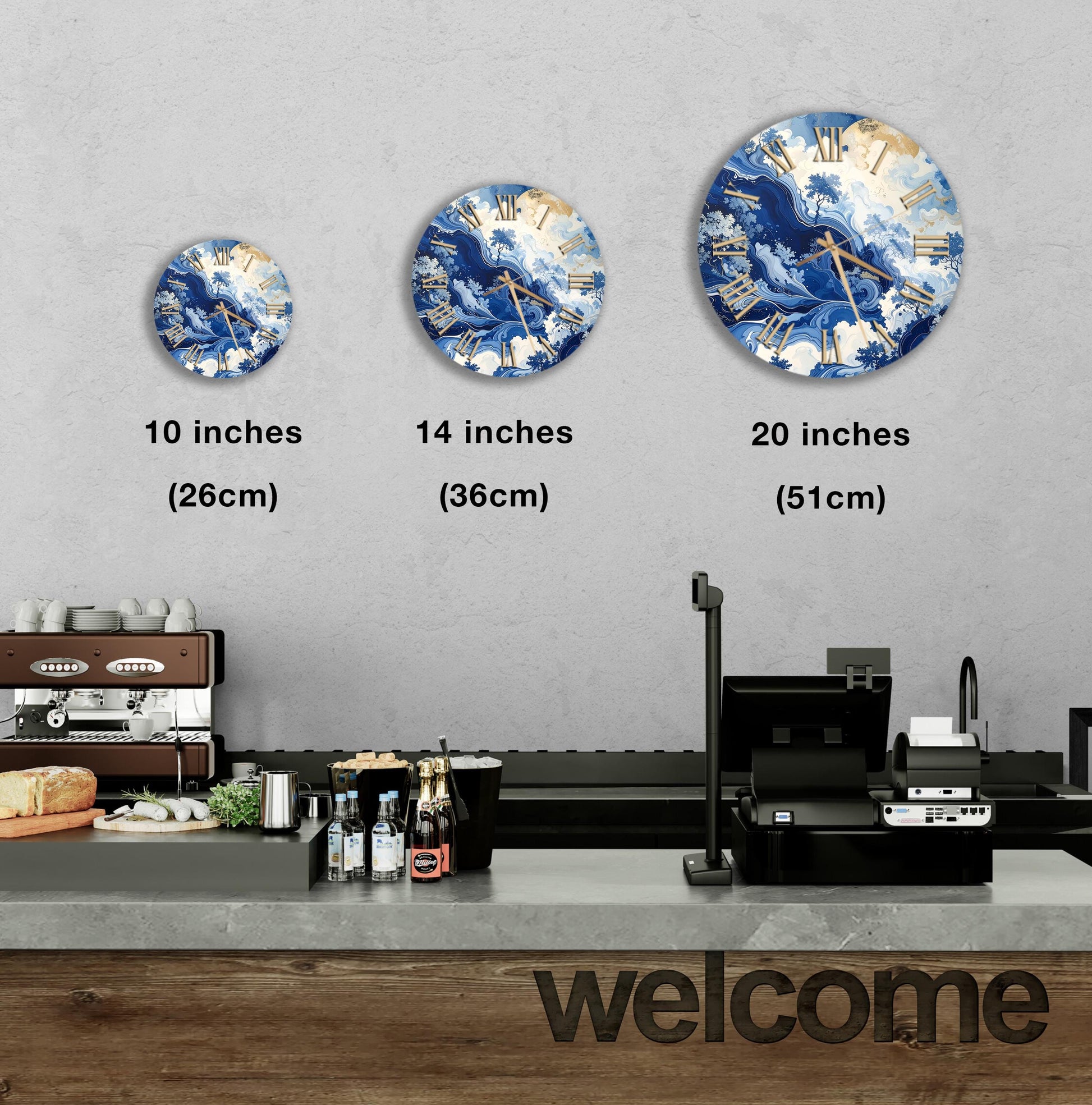 a wall with three clock designs of different sizes, ranging from 10 inches to 20 inches in diameter. Below the clocks, there is a counter with various items such as bottles and a sandwich. The word "welcome" is also visible in the image.