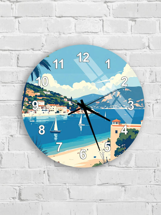 A round wall clock with a beach scene and sailboats on the water displayed on its face.