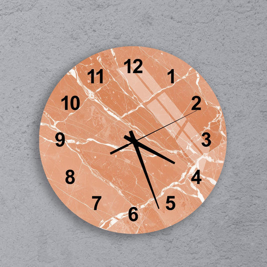 A round wall clock with a marble-like texture and black numbers on a light orange background.