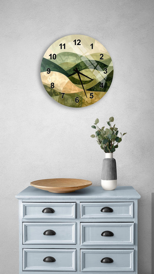 a wall clock with a green and brown abstract design, mounted on a wall above a light blue dresser with six drawers. The dresser also has a vase with greenery and a wooden bowl on top.
