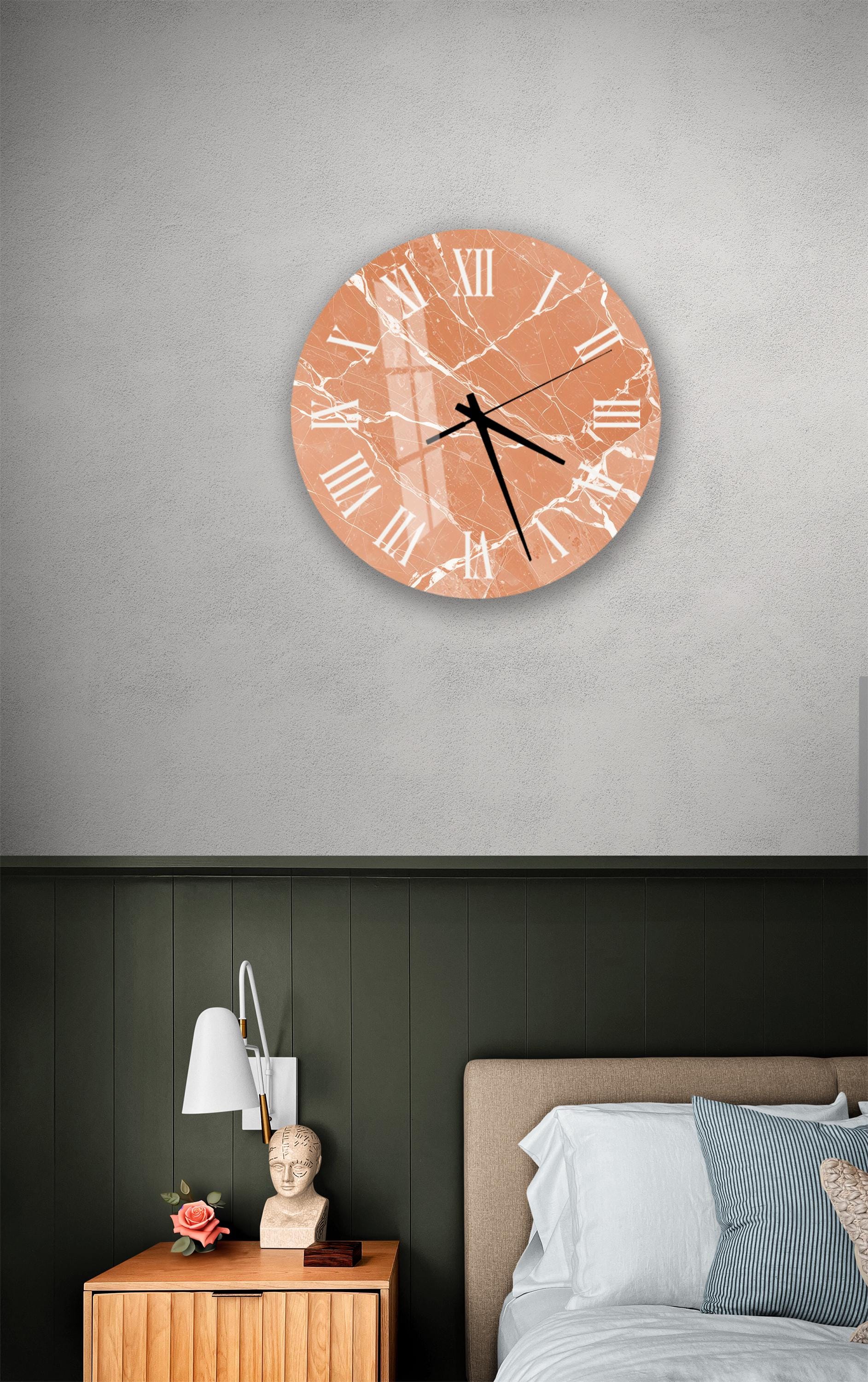 a bedroom setting with a wall clock, a nightstand, and a bed.