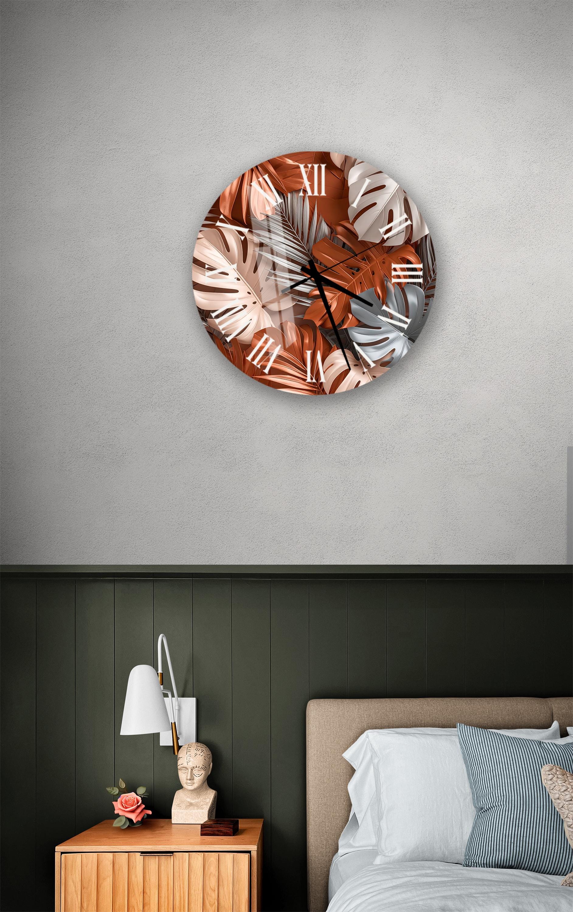 a bedroom setting with a round wall clock displaying a tropical leaf pattern, a wooden nightstand with a lamp, and a bed with white bedding.