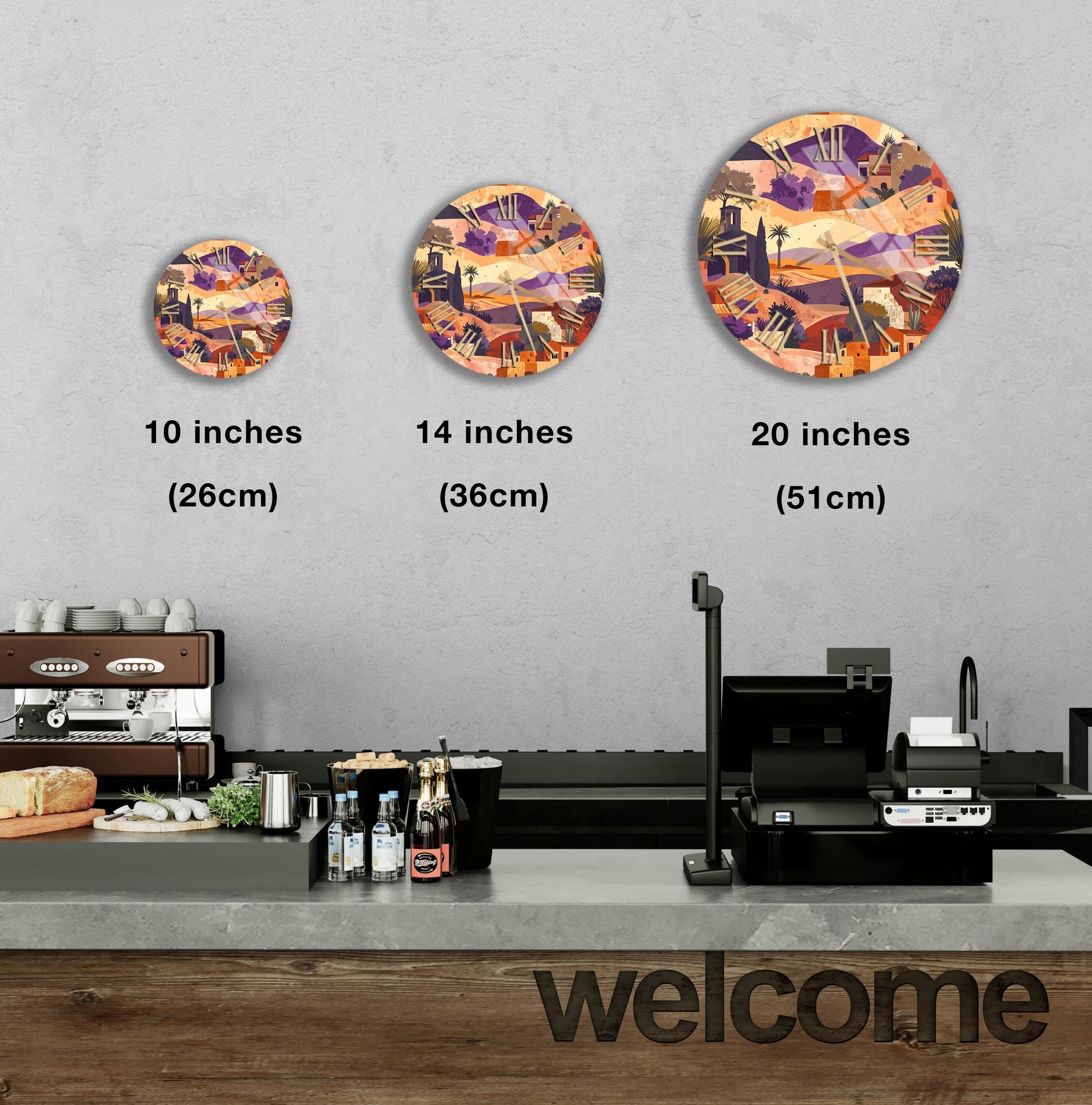 a counter in a restaurant with a "welcome" sign, and three different-sized circular plates with a colorful abstract design are displayed on the wall above the counter.