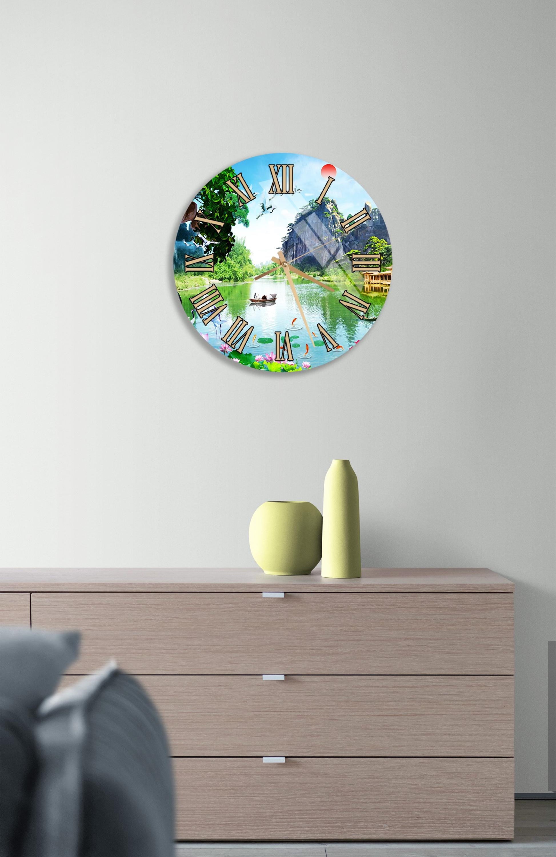 a clock with a colorful, nature-inspired design hanging on a wall above a wooden dresser.