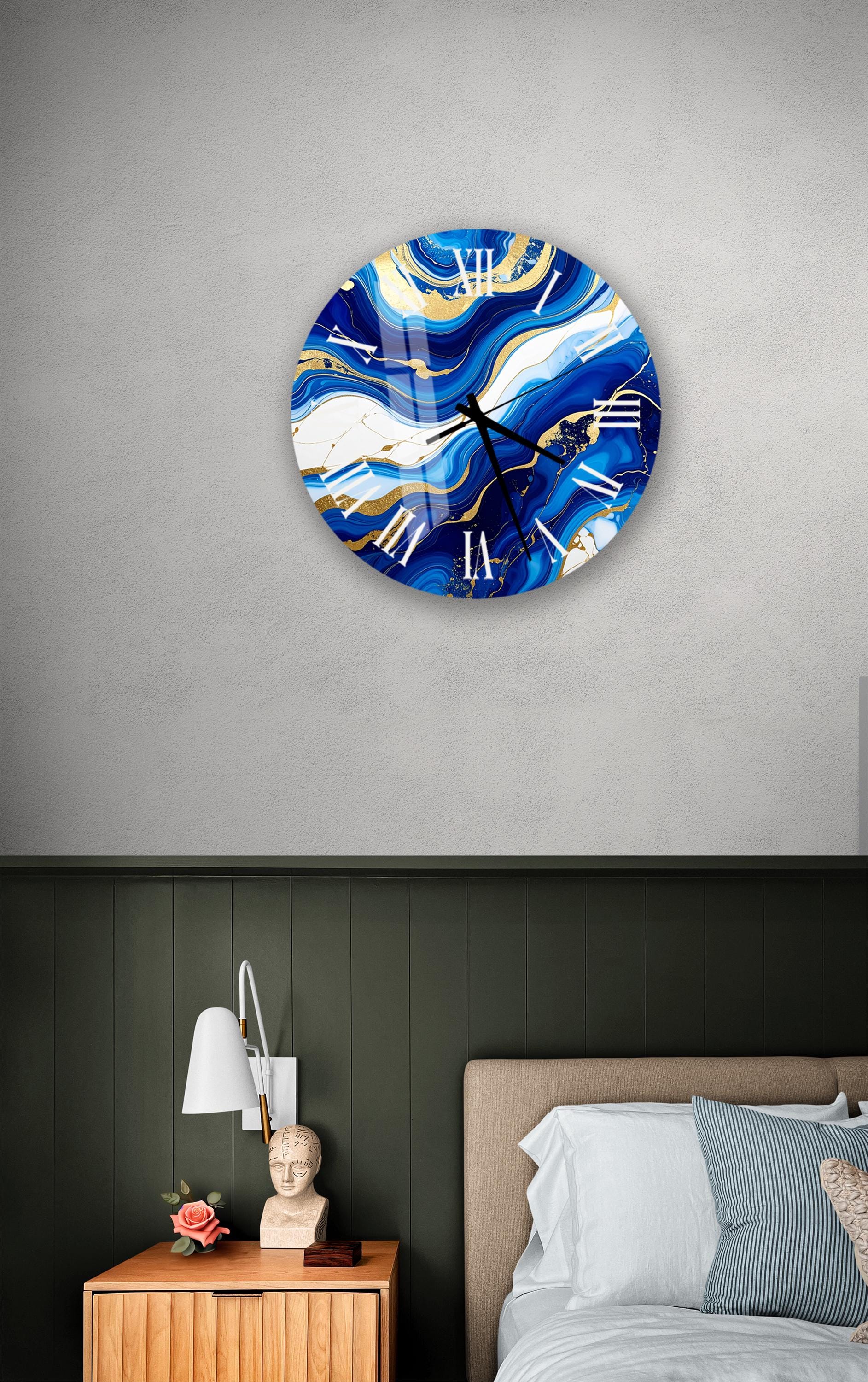a bedroom setting with a large, round clock with a blue and white marble design hanging on the wall above a bed with a white headboard.