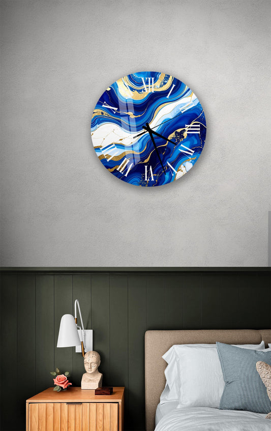 a bedroom setting with a large, round clock with a blue and white marble design hanging on the wall above a bed with a white headboard.