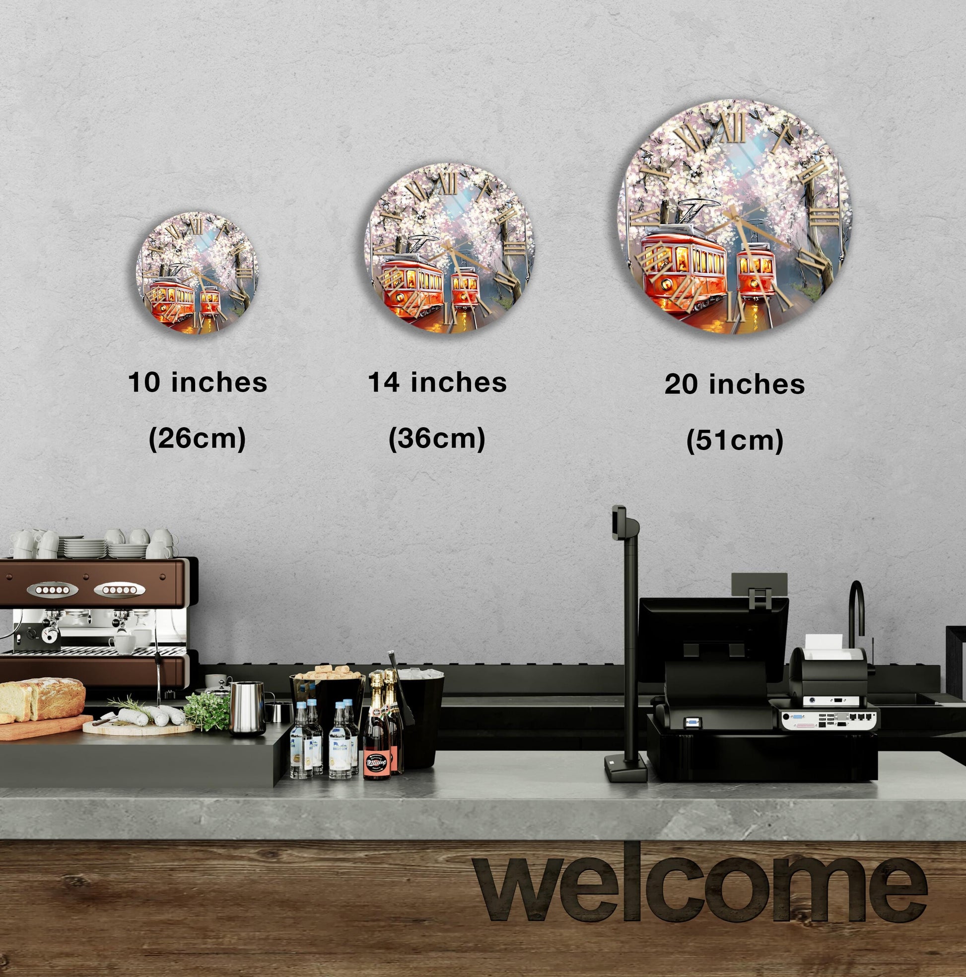 a counter with a cash register, a coffee machine, and various food items such as bottles and bread. Above the counter, there are three round wall decals depicting a trolley car, a tree, and a building. The decals are labeled with the sizes of the objects in inches, ranging from 10 to 20.