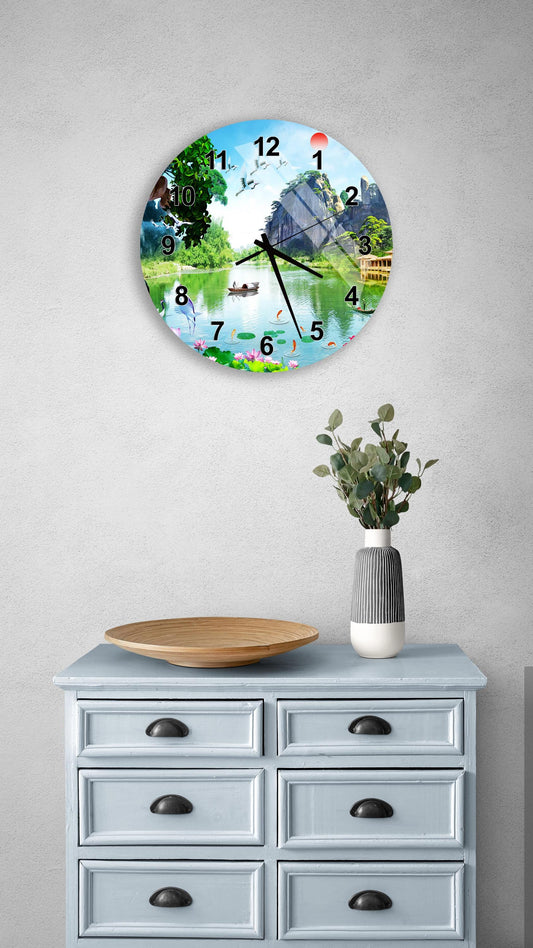 a wall clock with a scenic landscape design, mounted on a wall above a light blue dresser with drawers.