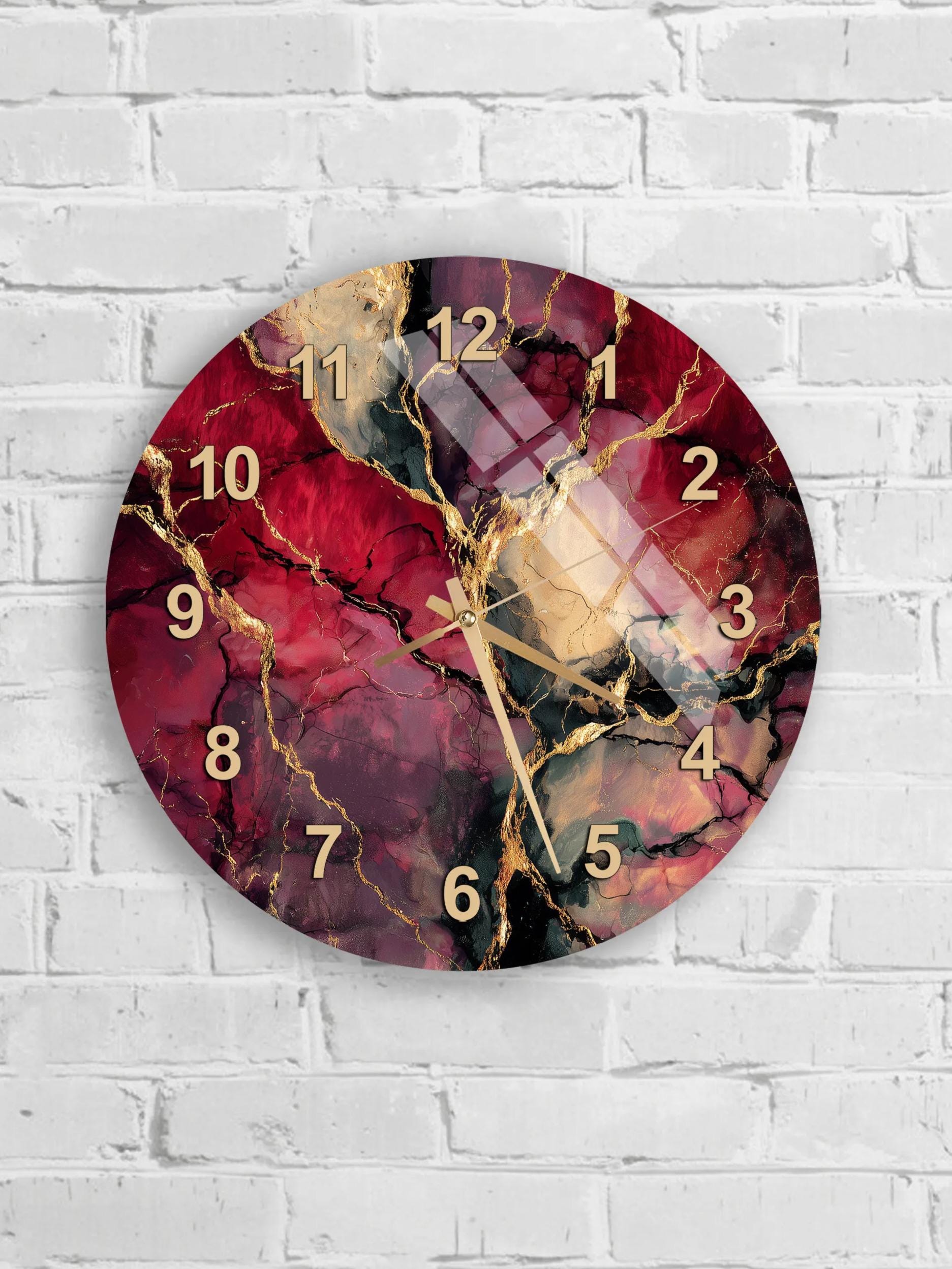 A round wall clock with a marbled design in red, black, and gold colors.