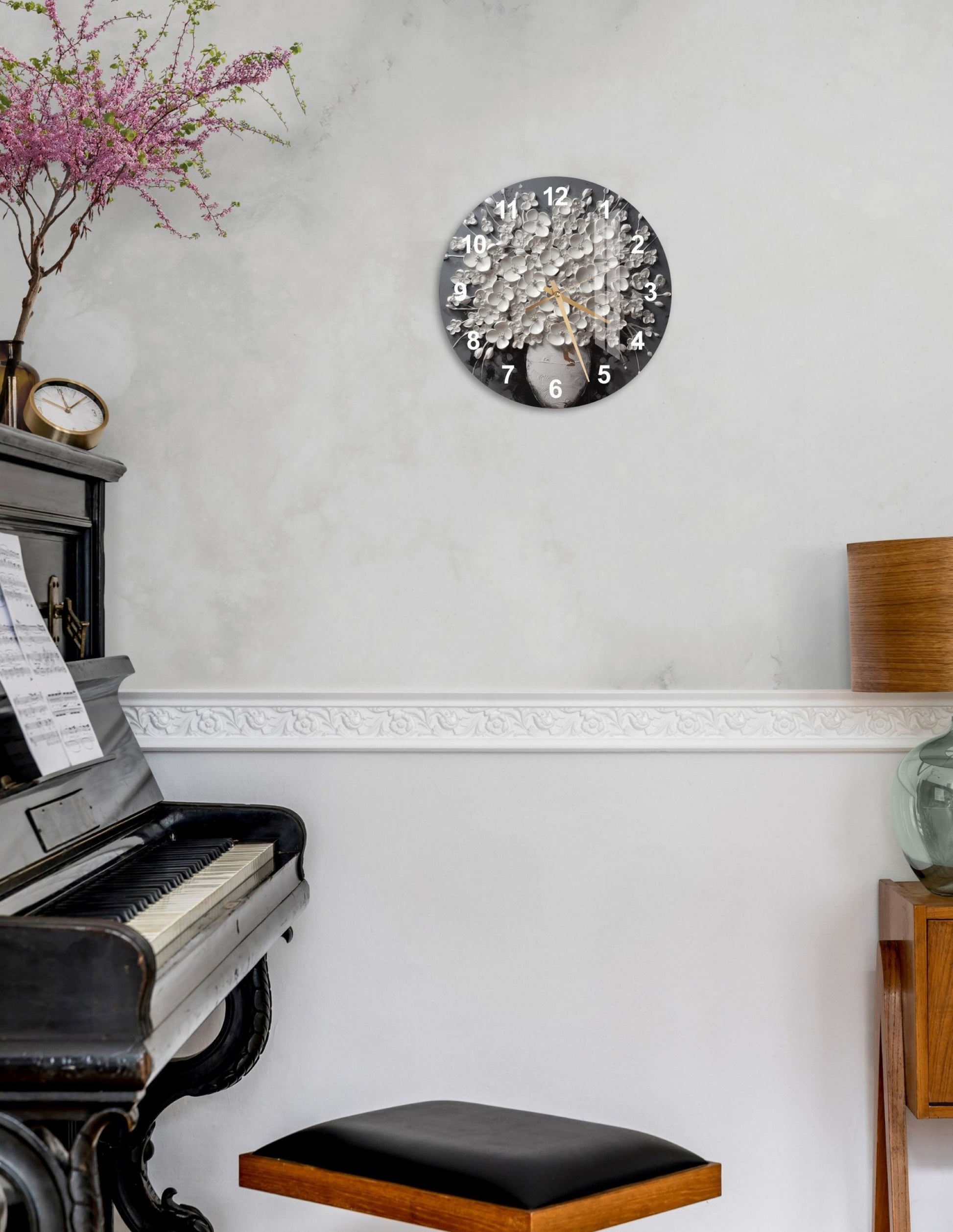 a piano sitting in a living room next to a clock