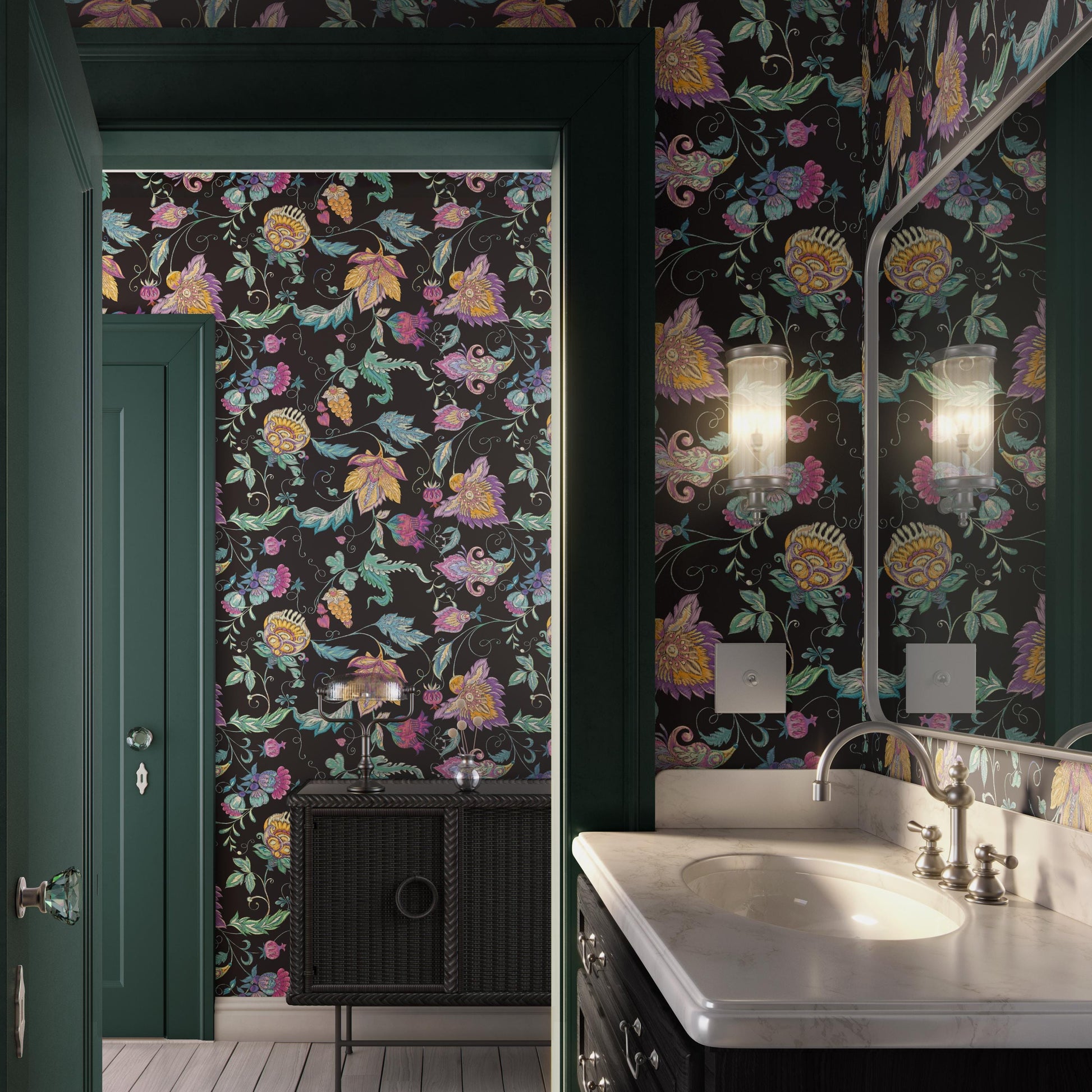 a bathroom with a floral patterned wallpaper, a white sink, and a mirror. The room has a green door and a black cabinet, creating a cohesive color scheme.