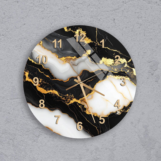 A wall clock with a marble-like design featuring black, white, and gold colors.