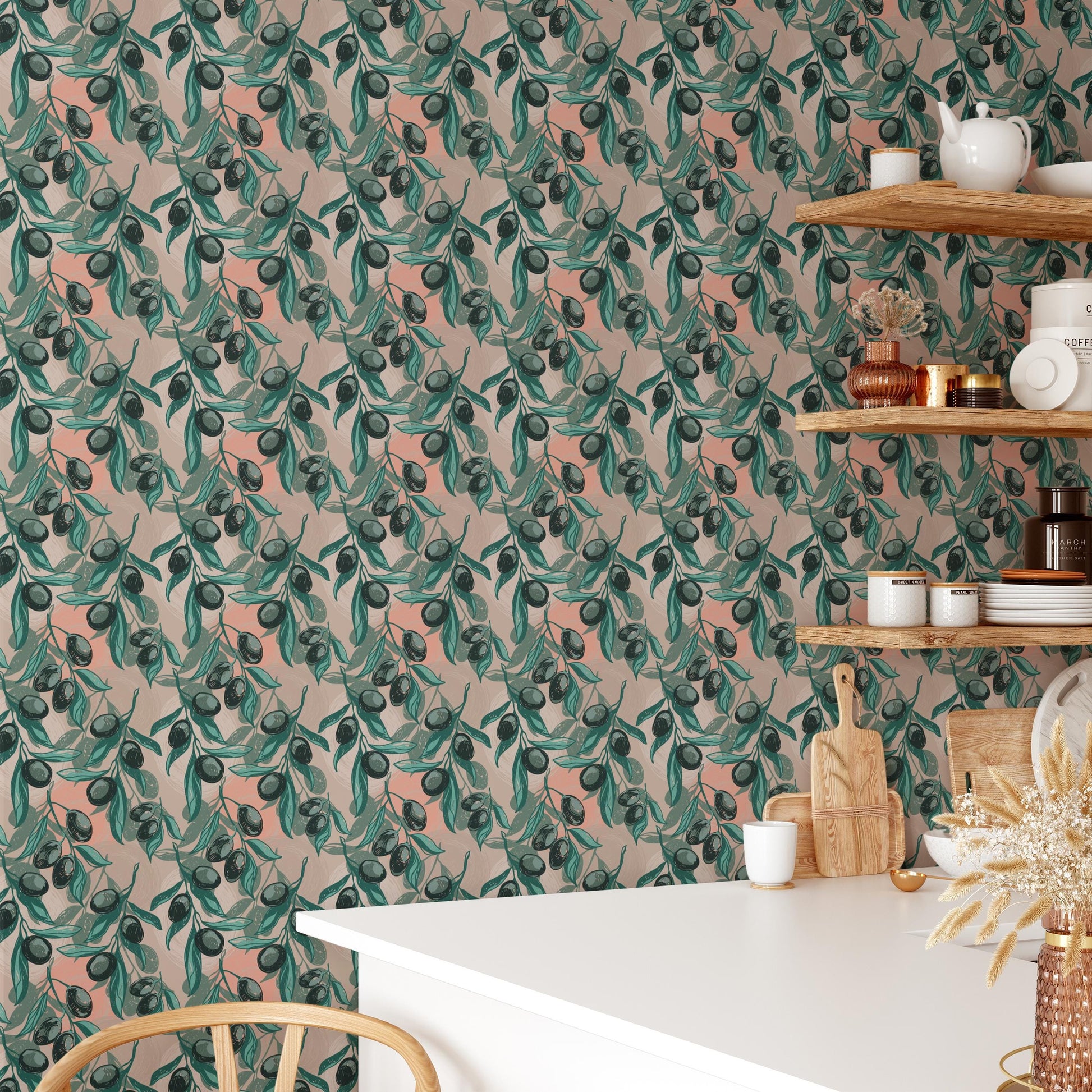 a kitchen with a white table and shelves displaying various kitchen items, including a vase with flowers, a teapot, and a wooden cutting board. The wall behind the table has a repeating pattern of green leaves and flowers, creating a vibrant and lively atmosphere.