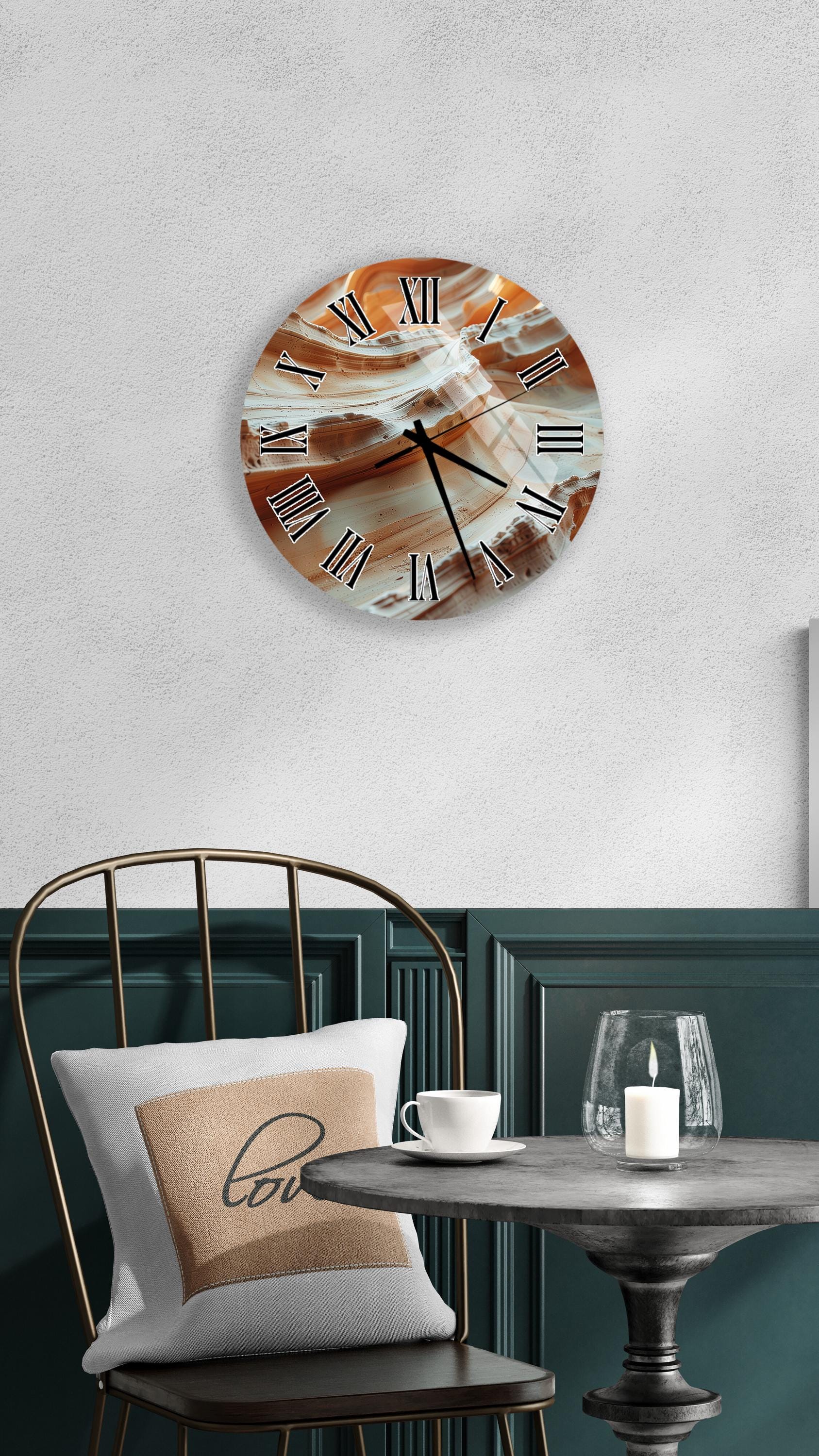 a modern interior design with a round wall clock displaying a swirling pattern, a white table with a candle and a glass, and a black metal chair with a white pillow.