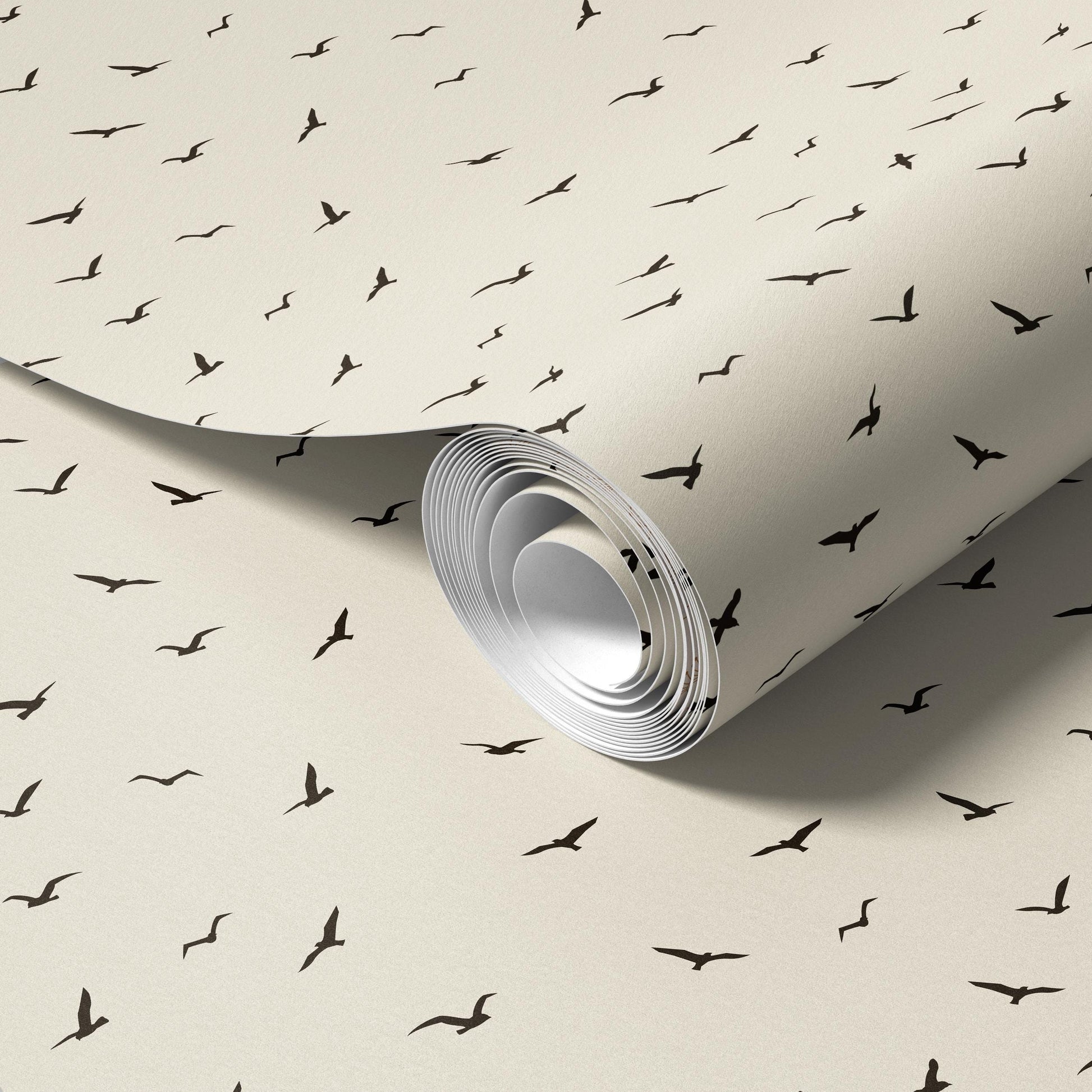 a roll of wallpaper with a repeating pattern of black silhouettes of birds.
