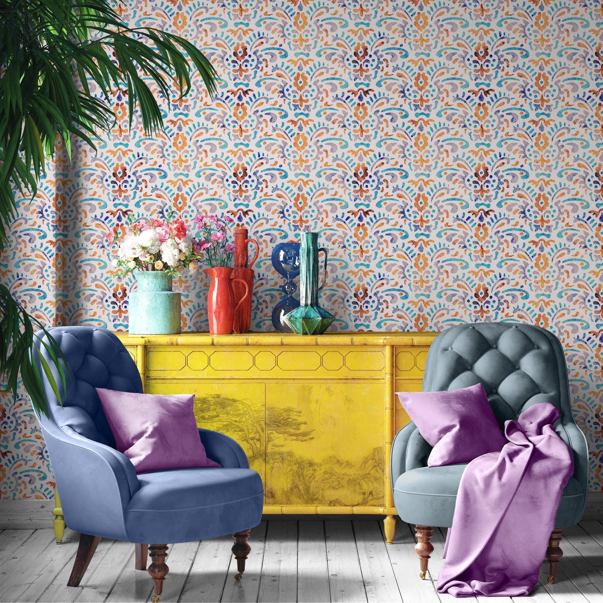 a vibrant and eclectic living space with a patterned wallpaper, two blue armchairs, a yellow sideboard, and a vase of flowers.