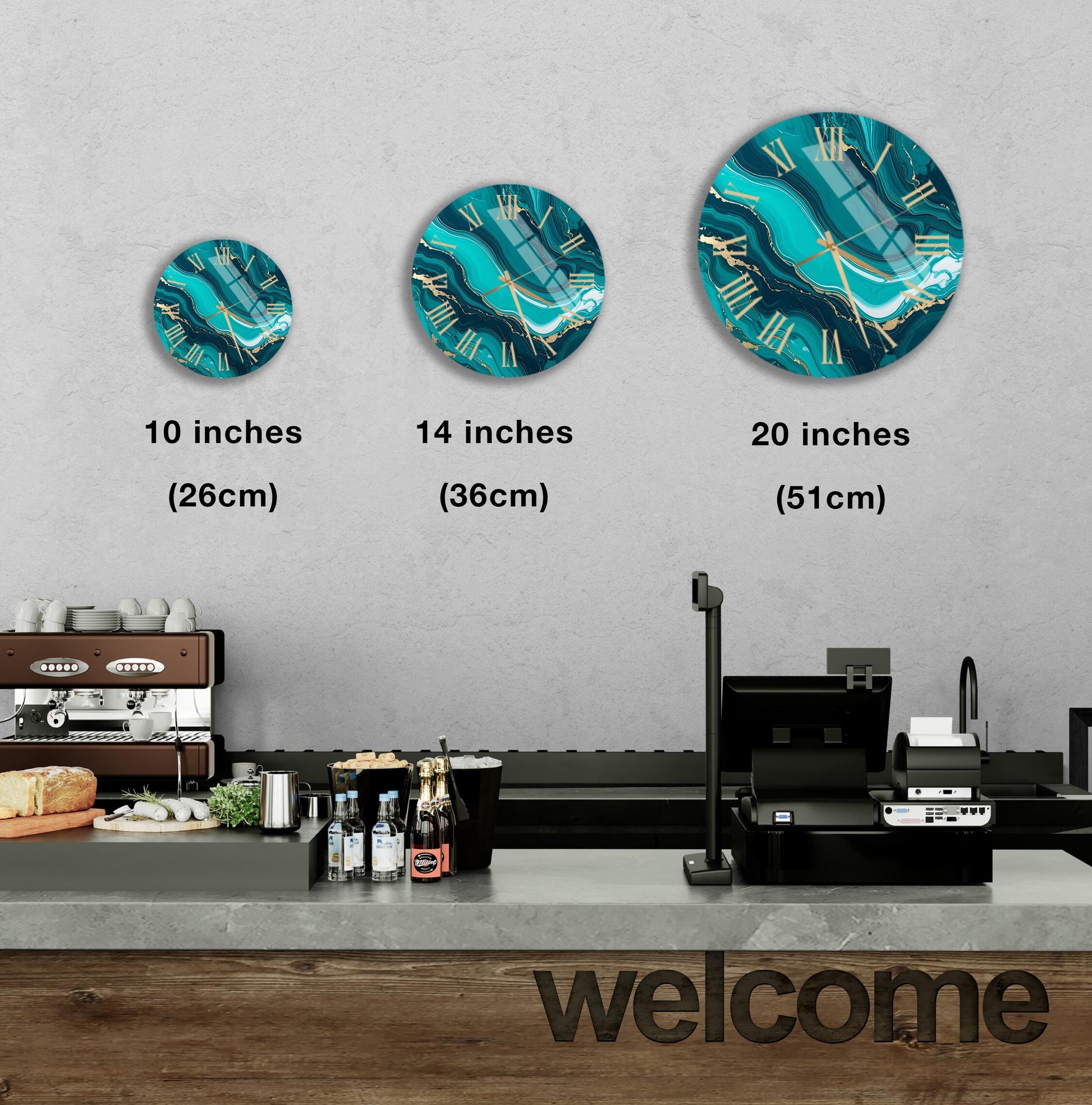 a wall with three clock designs of different sizes, and there is a counter with various items on it, such as bottles and a sandwich.