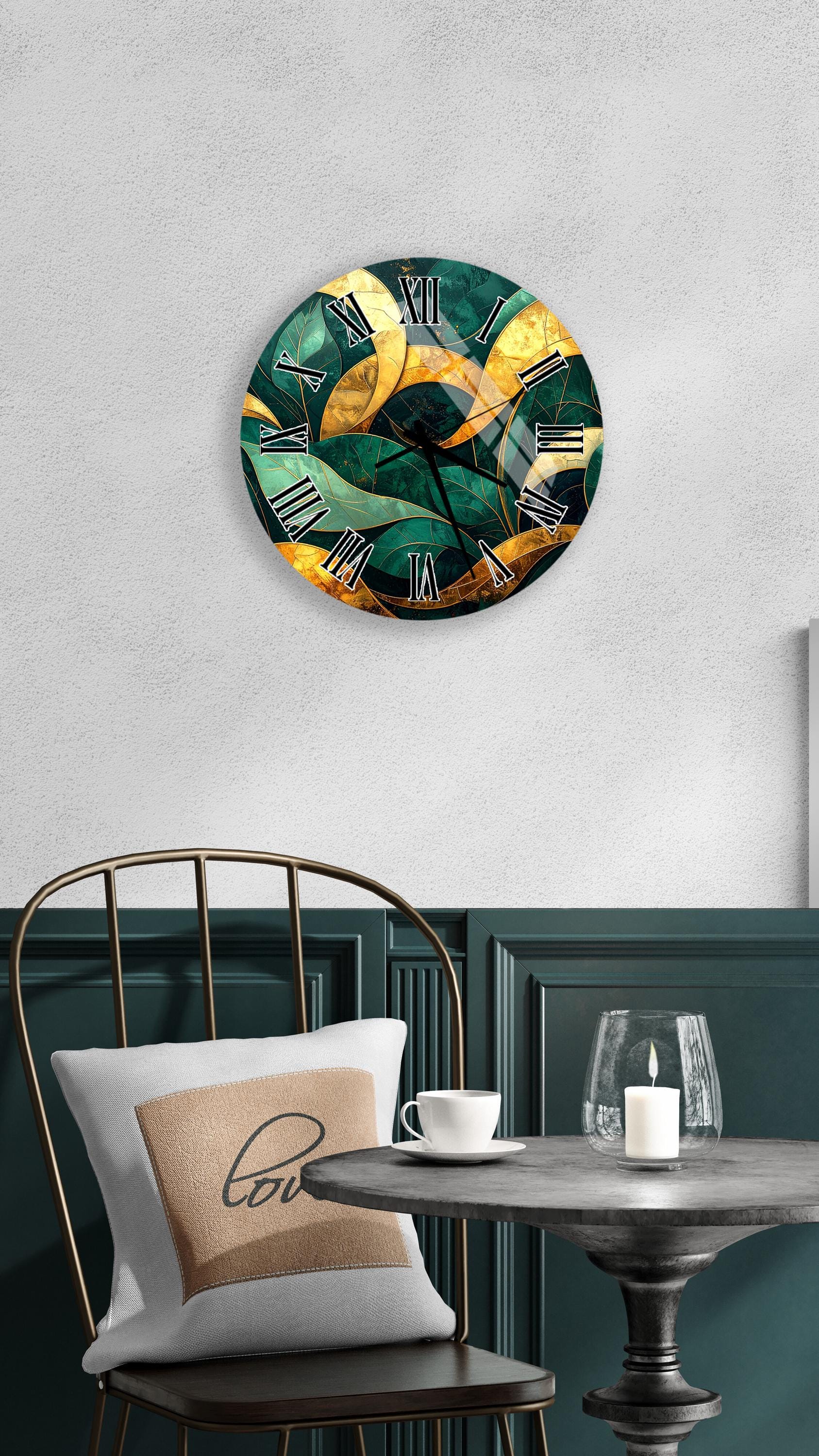 a modern, abstract clock with a green and gold color scheme, mounted on a wall above a table with a white tablecloth. The table is set with a white cup and a candle, creating a cozy and inviting atmosphere.