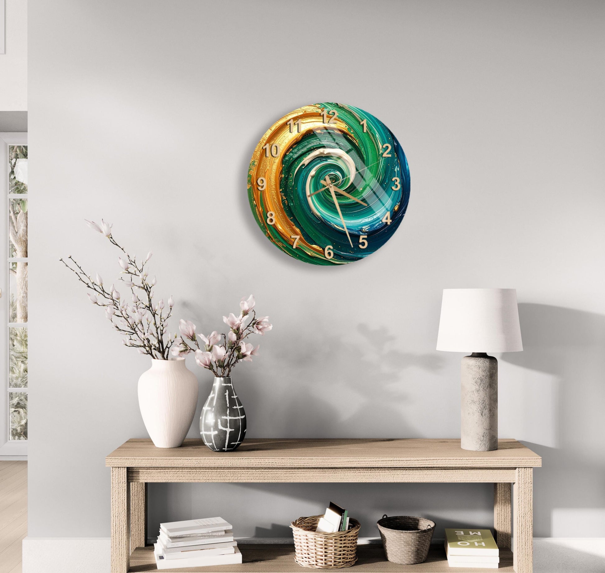 a modern, colorful clock with a swirling design on a light-colored wall, accompanied by a wooden table with a lamp, a vase with flowers, and a stack of books.