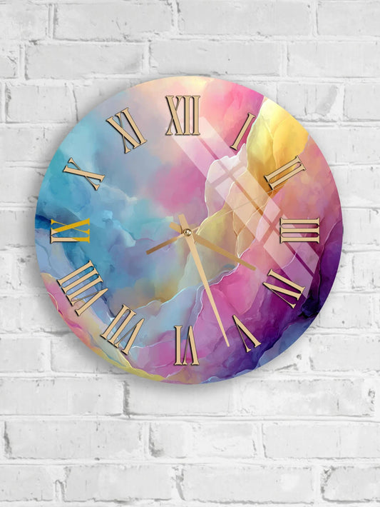 A round wall clock with a colorful abstract design featuring a gradient of pink, blue, and yellow colors.