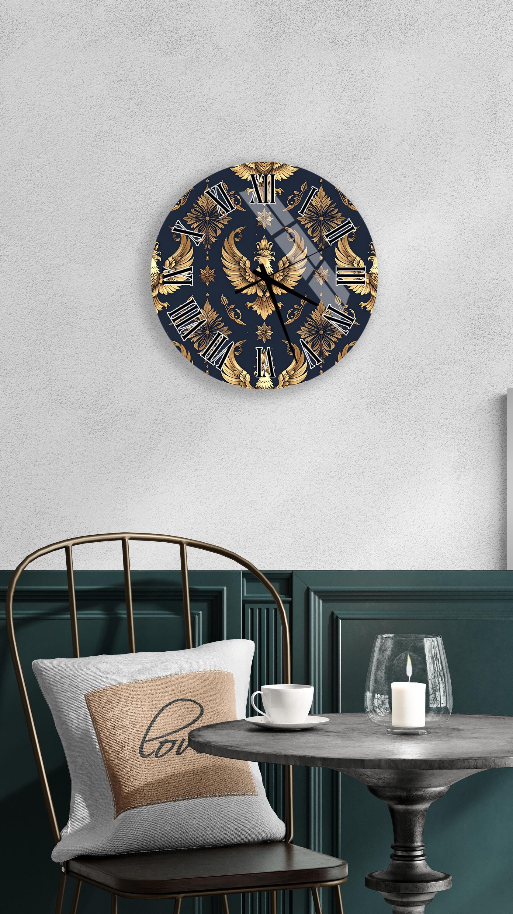 a modern and elegant interior design with a round wall clock featuring a gold and navy blue design, a white table with a candle and a cup, and a black chair with a white pillow.