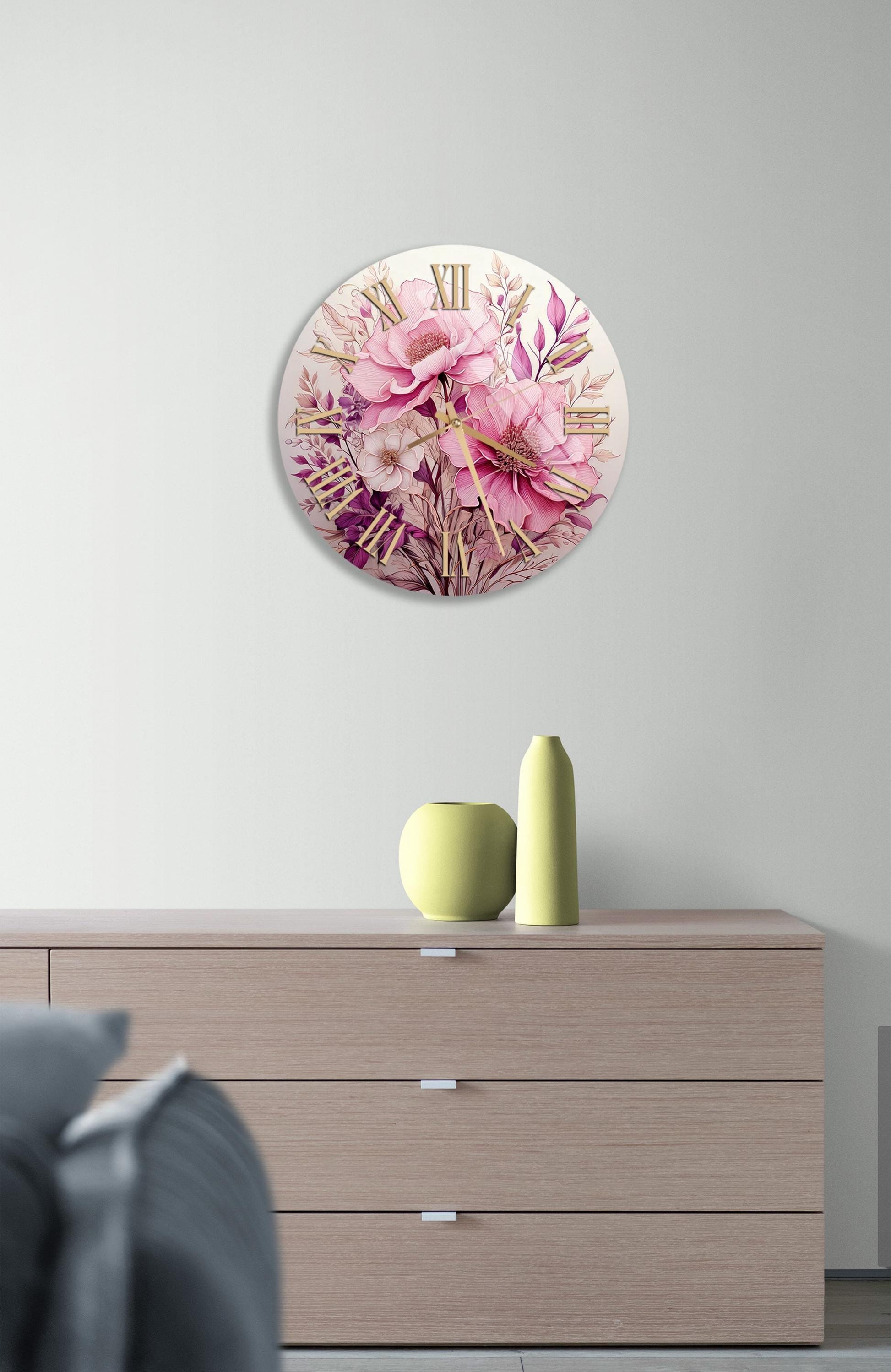 a white clock with pink flowers on it