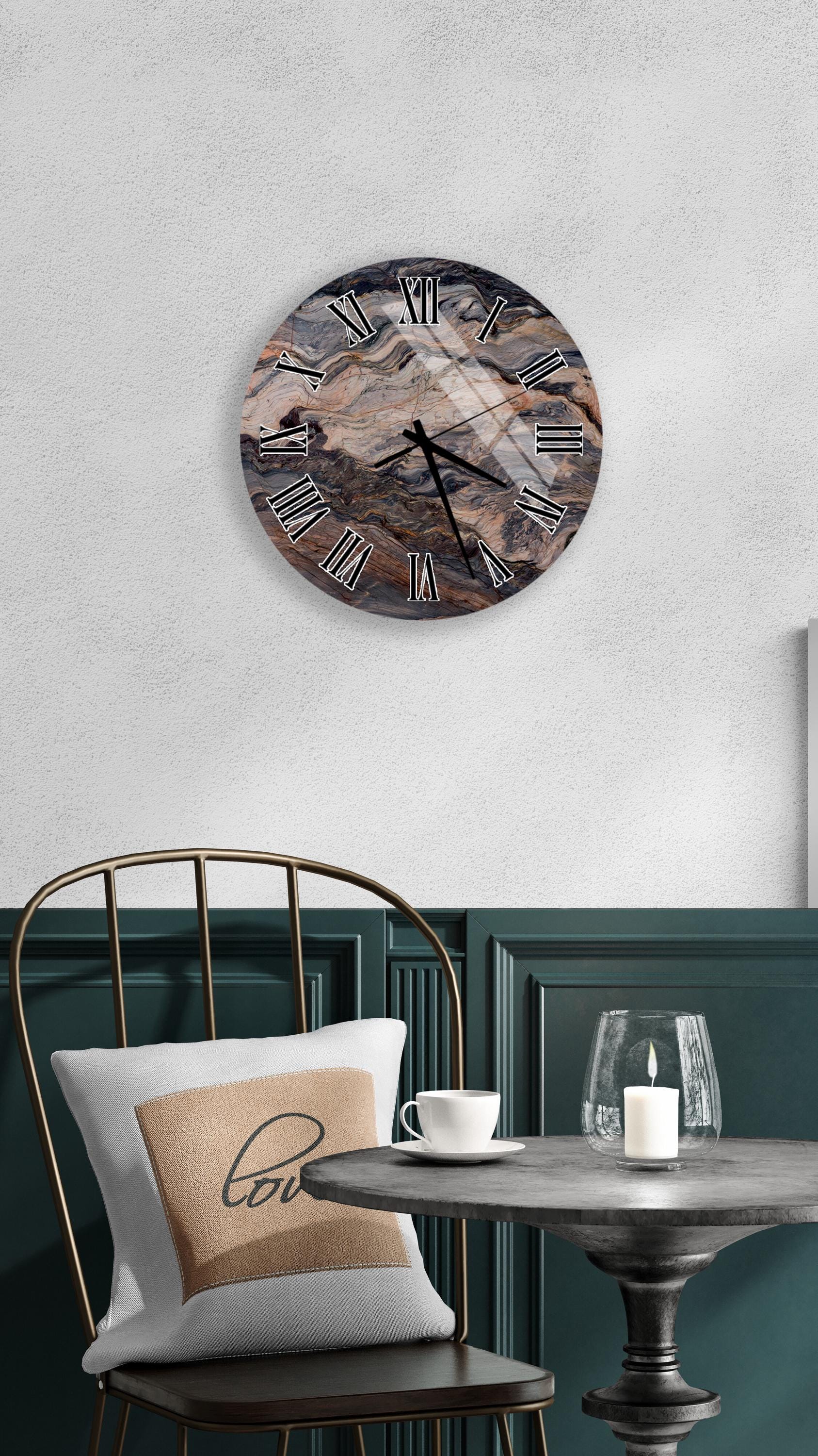 a modern interior design with a round wall clock, a white table with a candle, and a black metal chair.