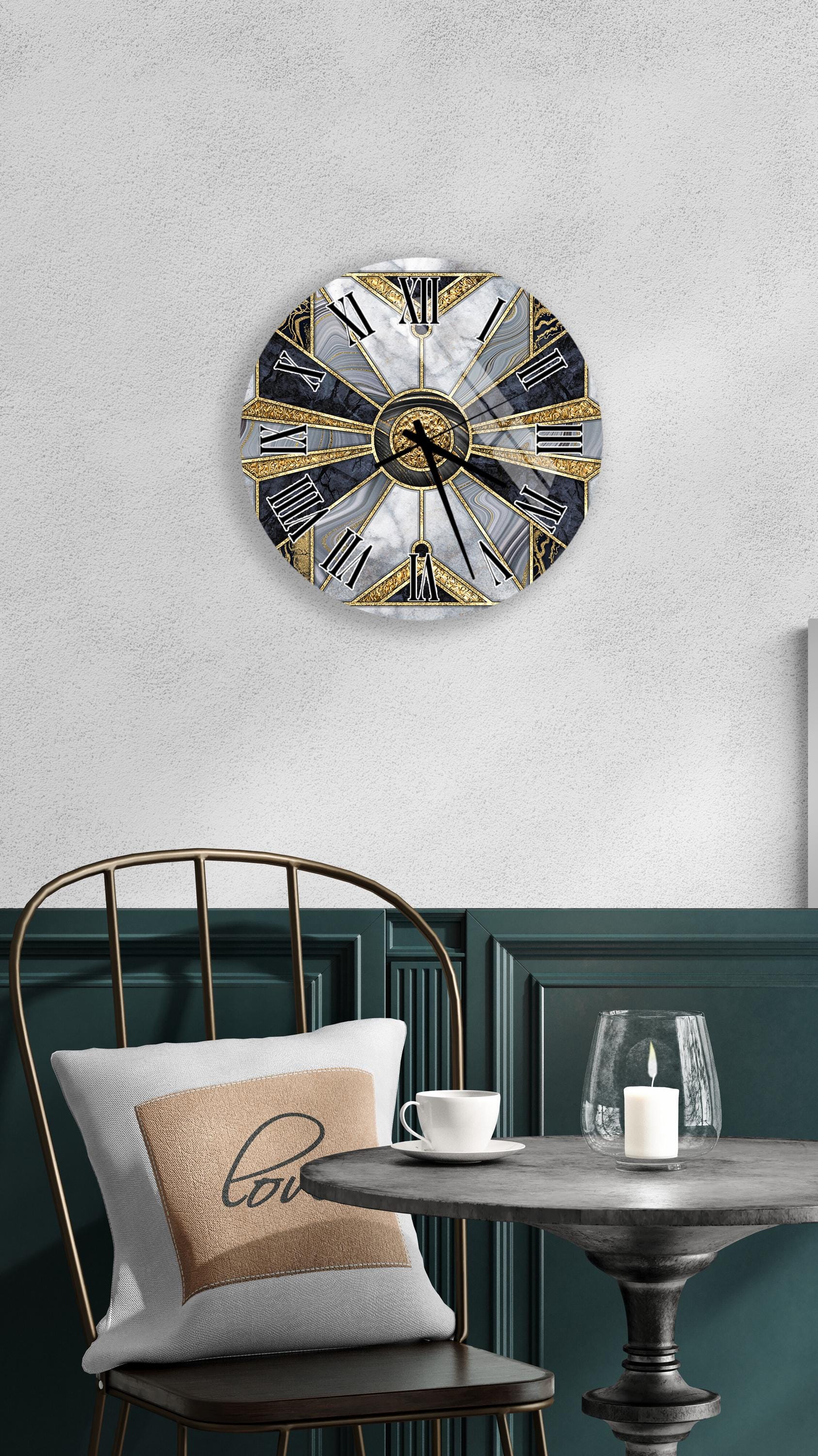 a modern and stylish interior design with a round wall clock, a black metal chair, a white table with a candle, and a beige pillow with a black design.