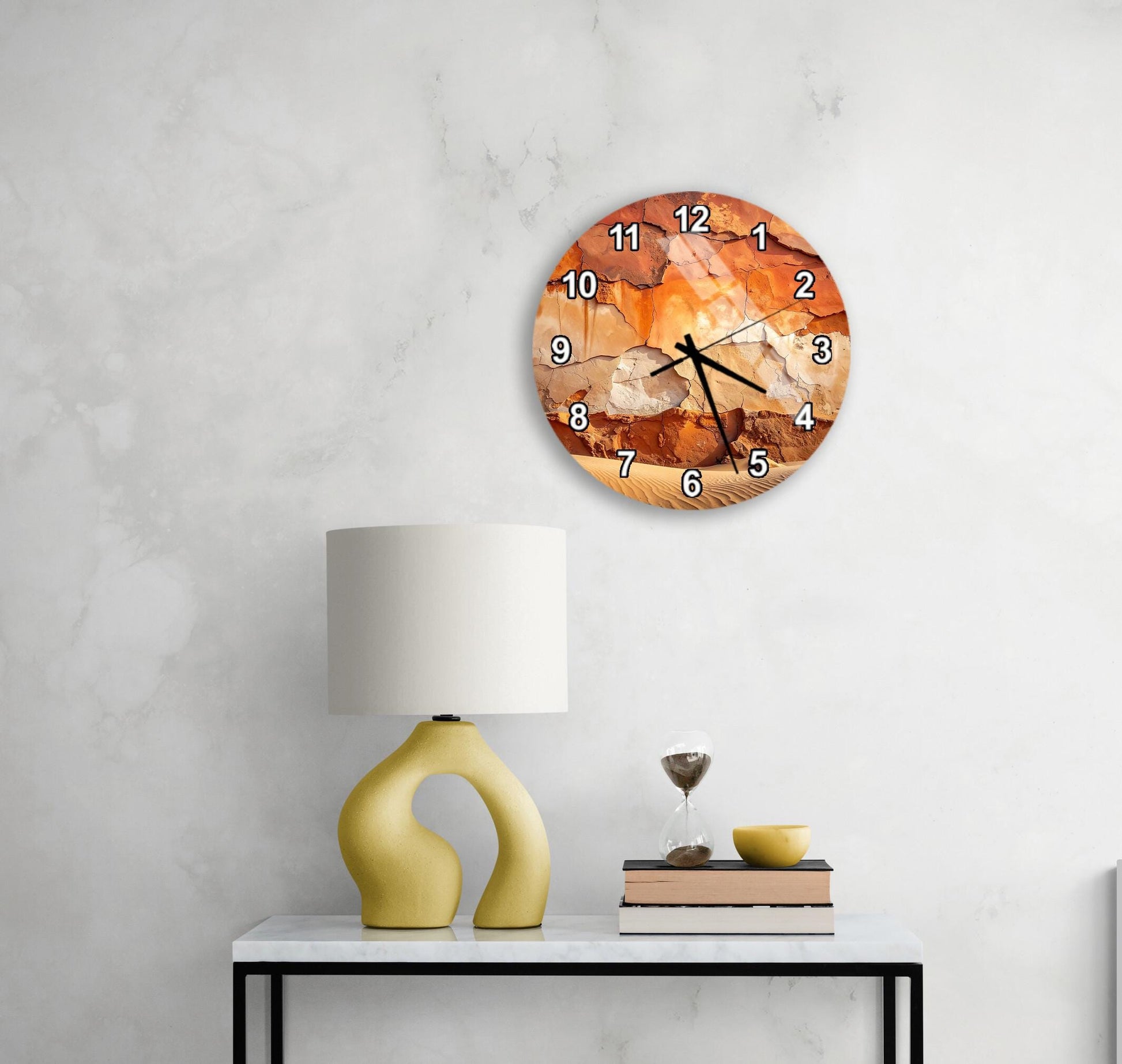 a modern living room with a round wall clock, a yellow lamp, a white table, and a stack of books.