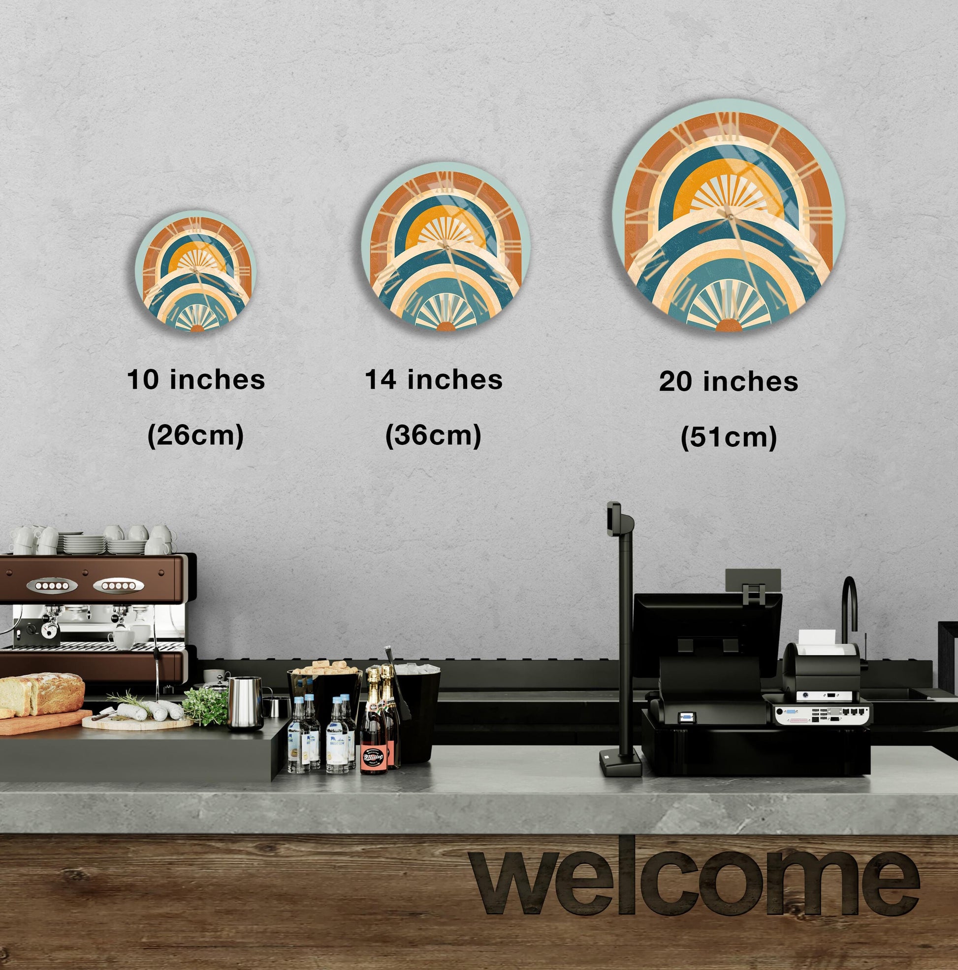 a counter in a restaurant with a welcome sign, and three different sizes of circular wall art displayed above the counter.