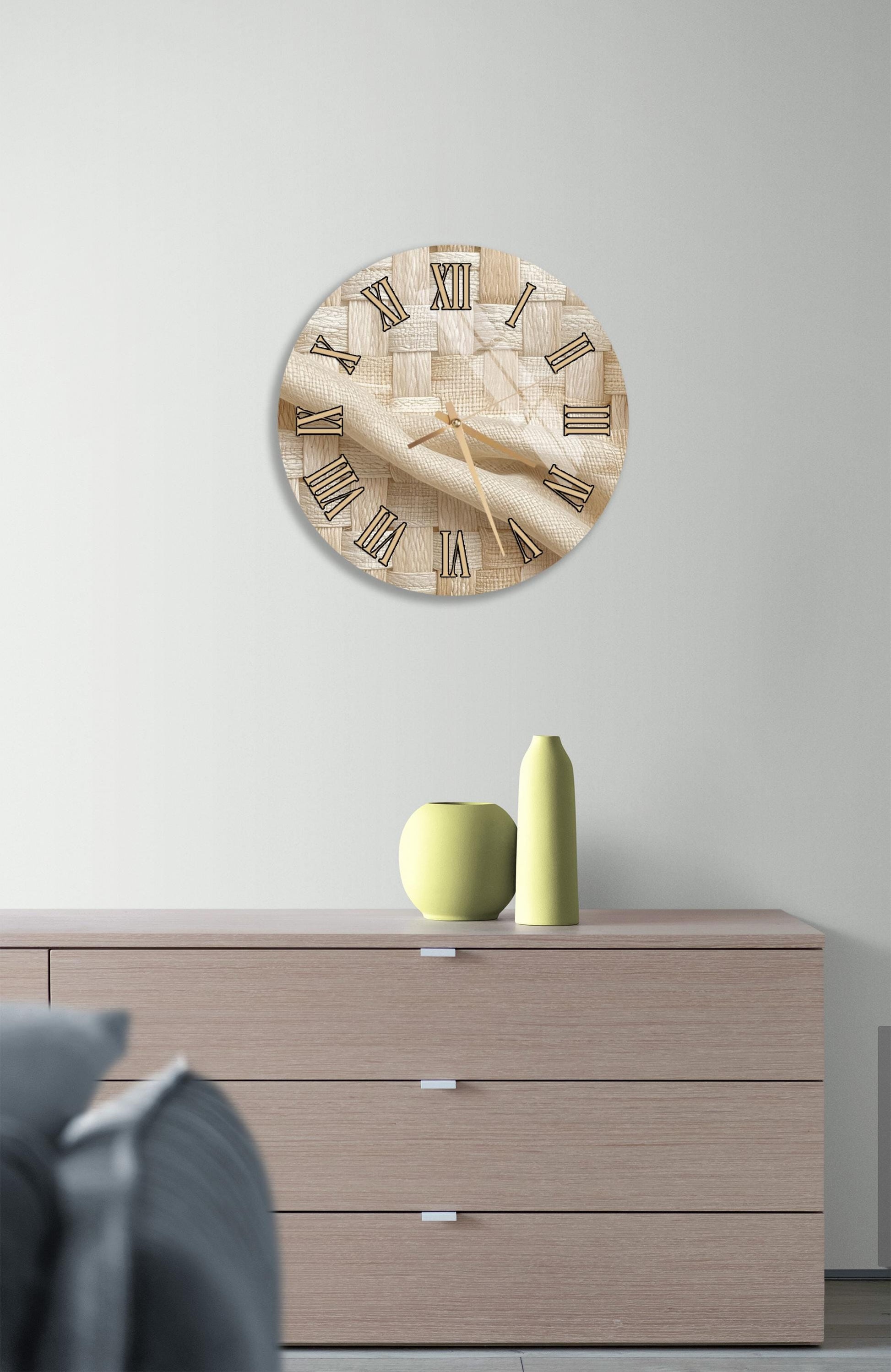 a wooden dresser with a round clock on the wall above it, and a small green vase on the dresser.