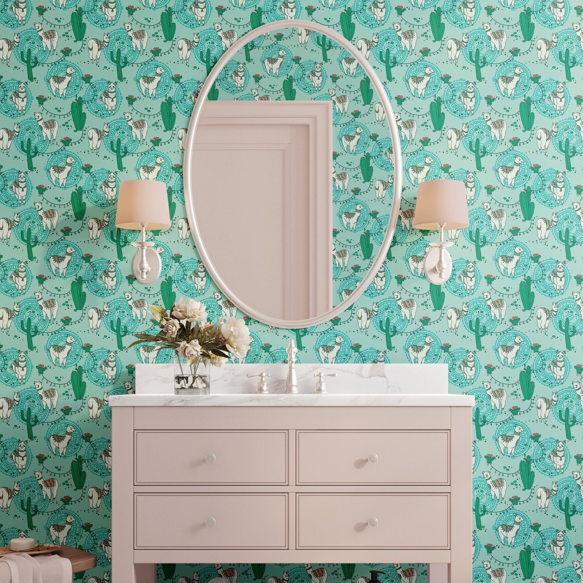 a bathroom with a white vanity and a large mirror above it. The wall behind the vanity has a vibrant, colorful pattern with various animals and cacti. There are two lamps on either side of the mirror, and a vase of flowers is placed on the vanity.