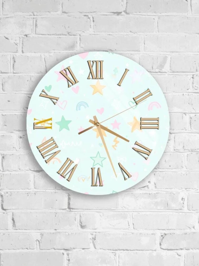 A round wall clock with Roman numerals and colorful decorative elements is mounted on a white brick wall.