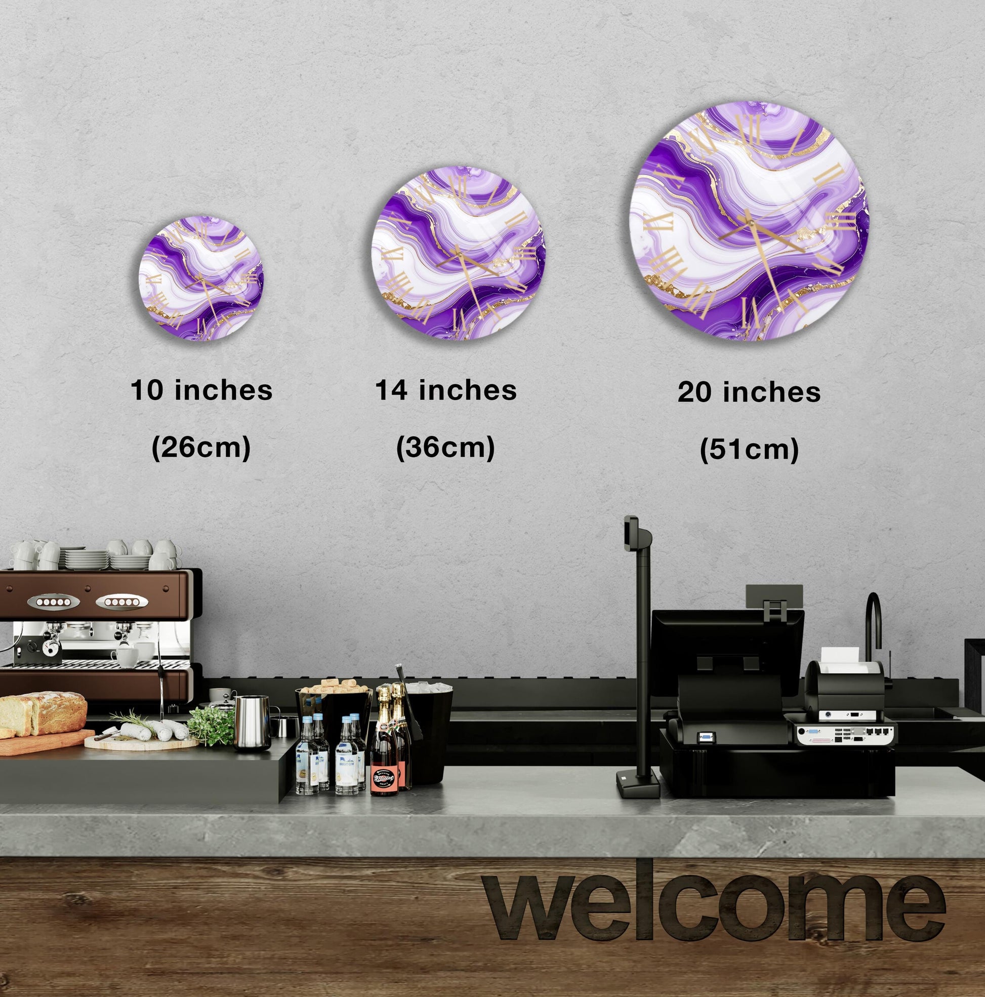 a counter in a restaurant with a "welcome" sign, and three different sizes of circular wall art or paintings hanging above the counter.