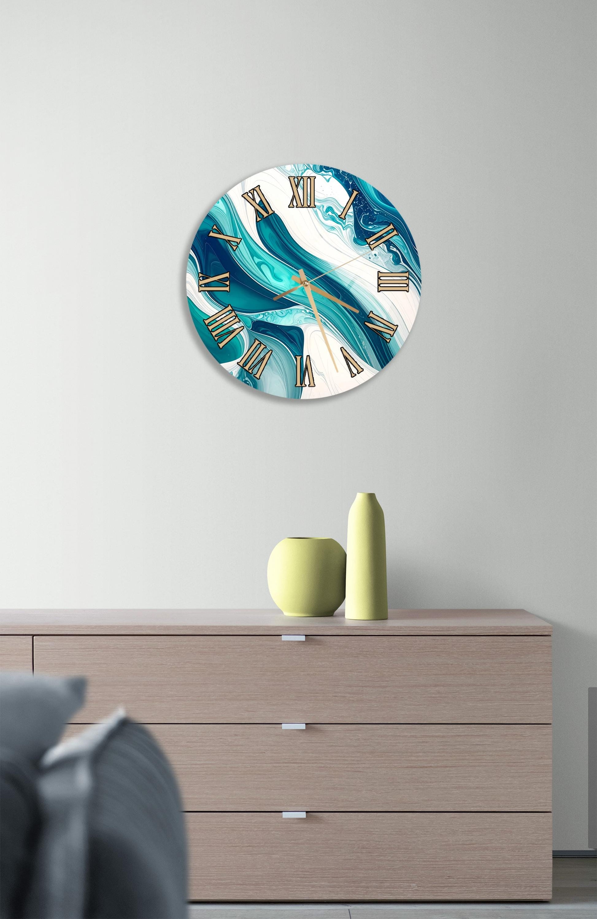 a wall clock with a marble-like design, mounted on a wall above a wooden dresser with three drawers. The dresser also has a small vase and a yellow bottle on it.
