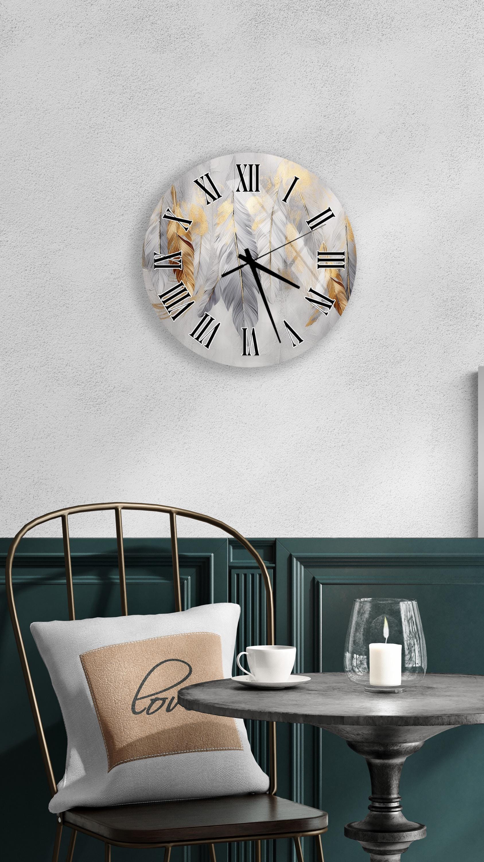 a modern and stylish interior design with a round wall clock, a white table with a candle, and a black chair with a pillow.