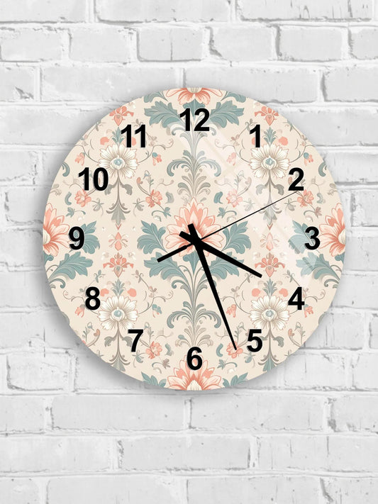 A round wall clock with a floral pattern on its face, mounted on a white brick wall.