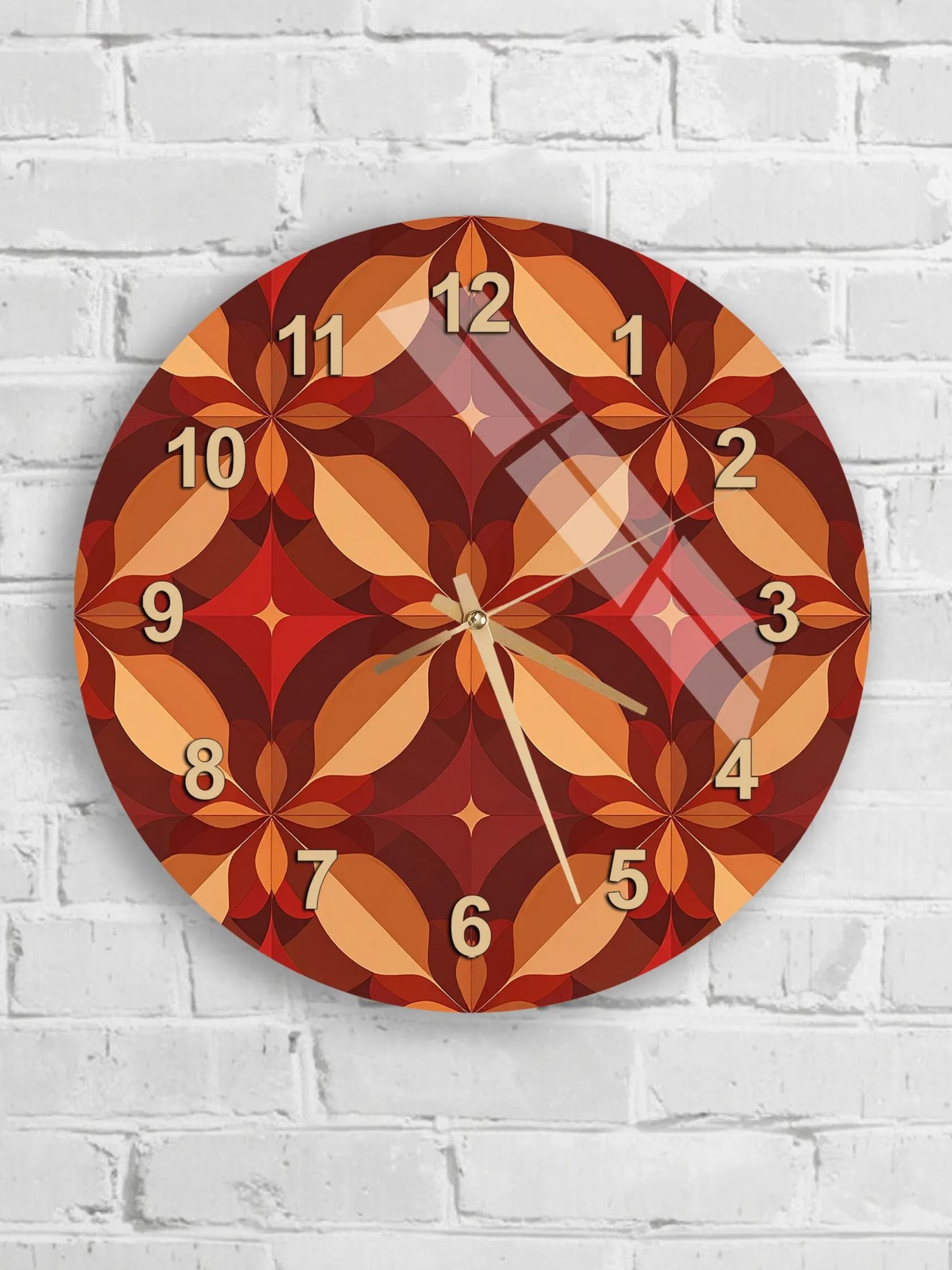 A wall clock with a vibrant, geometric pattern in shades of red, orange, and brown.