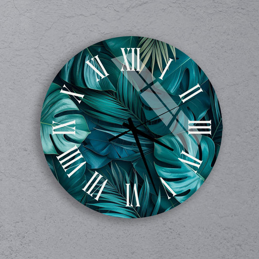 A round wall clock with a tropical leaf pattern on its face.