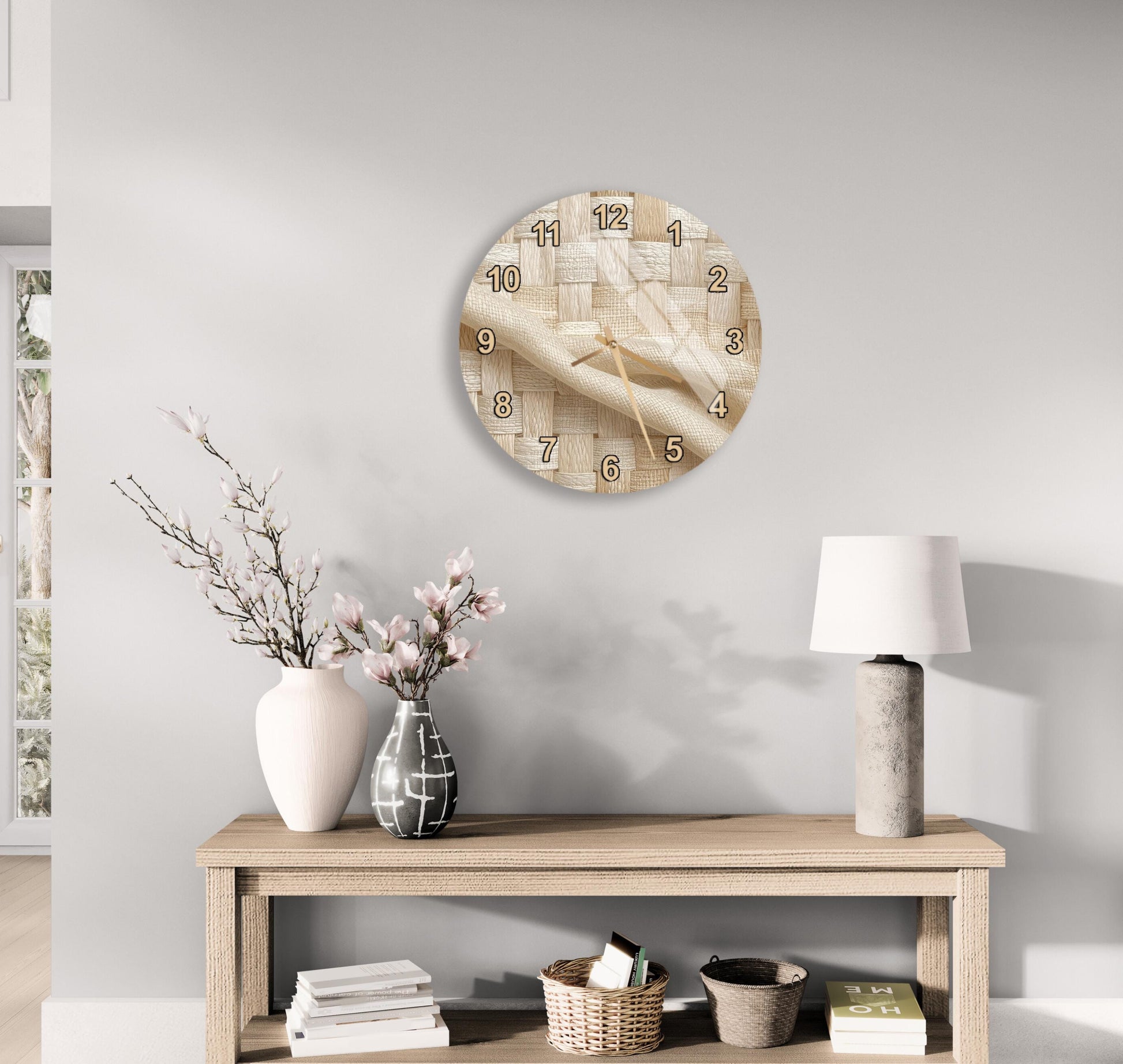 a wooden table with a clock, a vase with flowers, and a lamp on it. The table is set against a light-colored wall, and there are some books and decorative items on the table as well.