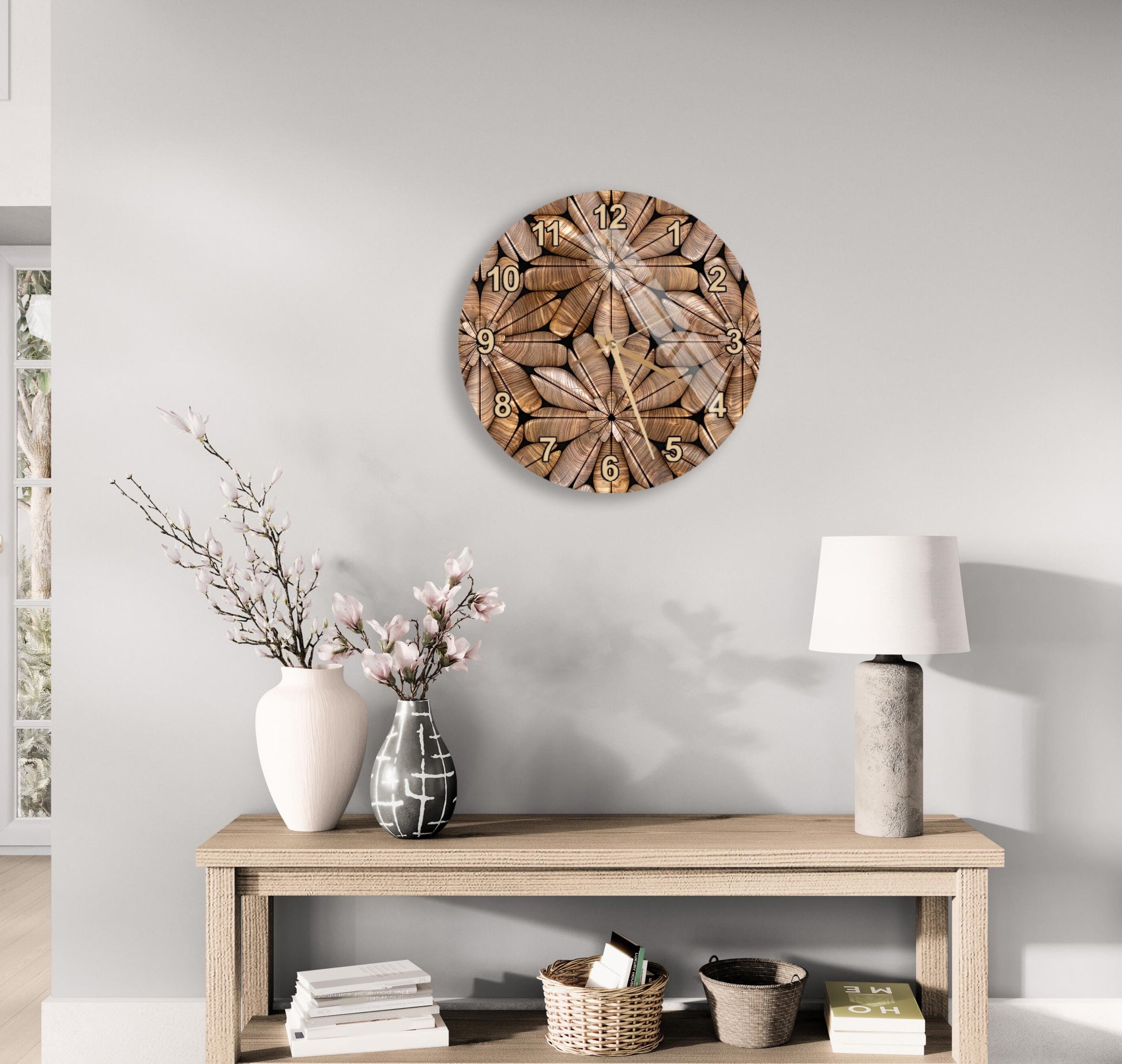 a wooden table with a lamp, a vase with flowers, and a clock on the wall above it.