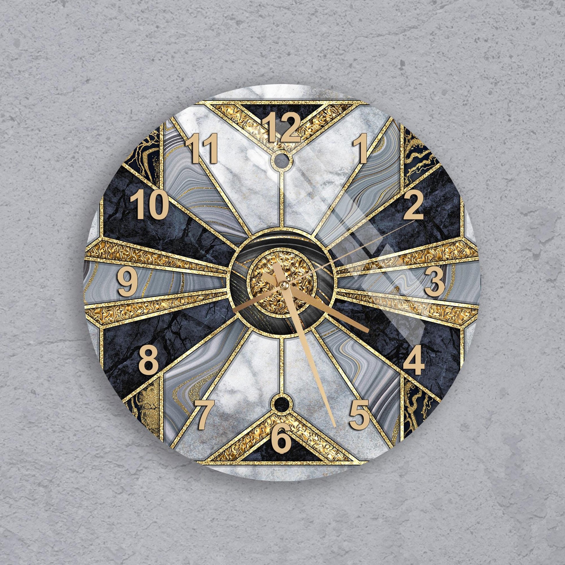 A wall clock with a gold and black marble design, featuring a central clock face with gold hands and numbers, and a dark background with a light gray texture.