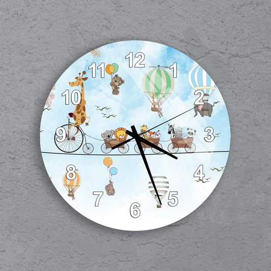 A clock with a whimsical design featuring various animals, including a giraffe, teddy bear, hot air balloons, and a train, all set against a blue sky background.