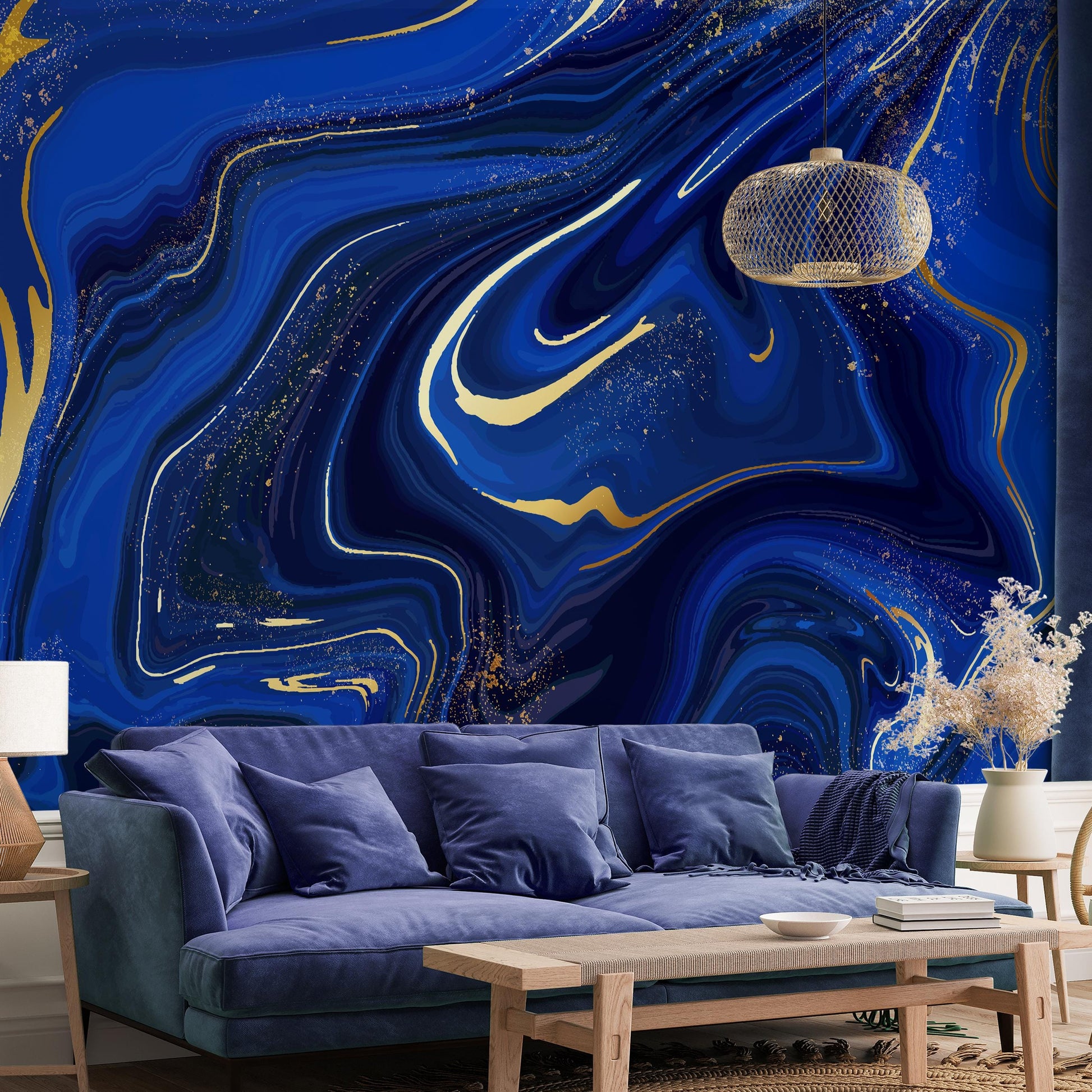 a living room with a blue sofa, a wooden coffee table, and a large abstract wall mural with swirling blue and gold patterns.