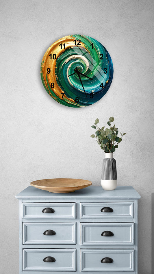 a wall clock with a spiral design in turquoise, gold, and white colors, mounted on a gray wall above a light blue dresser with six drawers. The dresser also has a vase with greenery and a wooden tray on top.