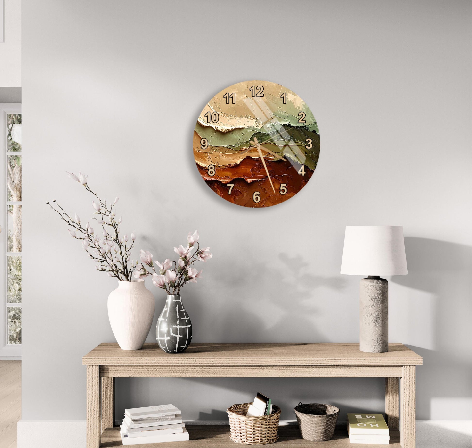 a wall clock with a colorful design, a wooden table with a lamp, a vase with flowers, and some books on a shelf.