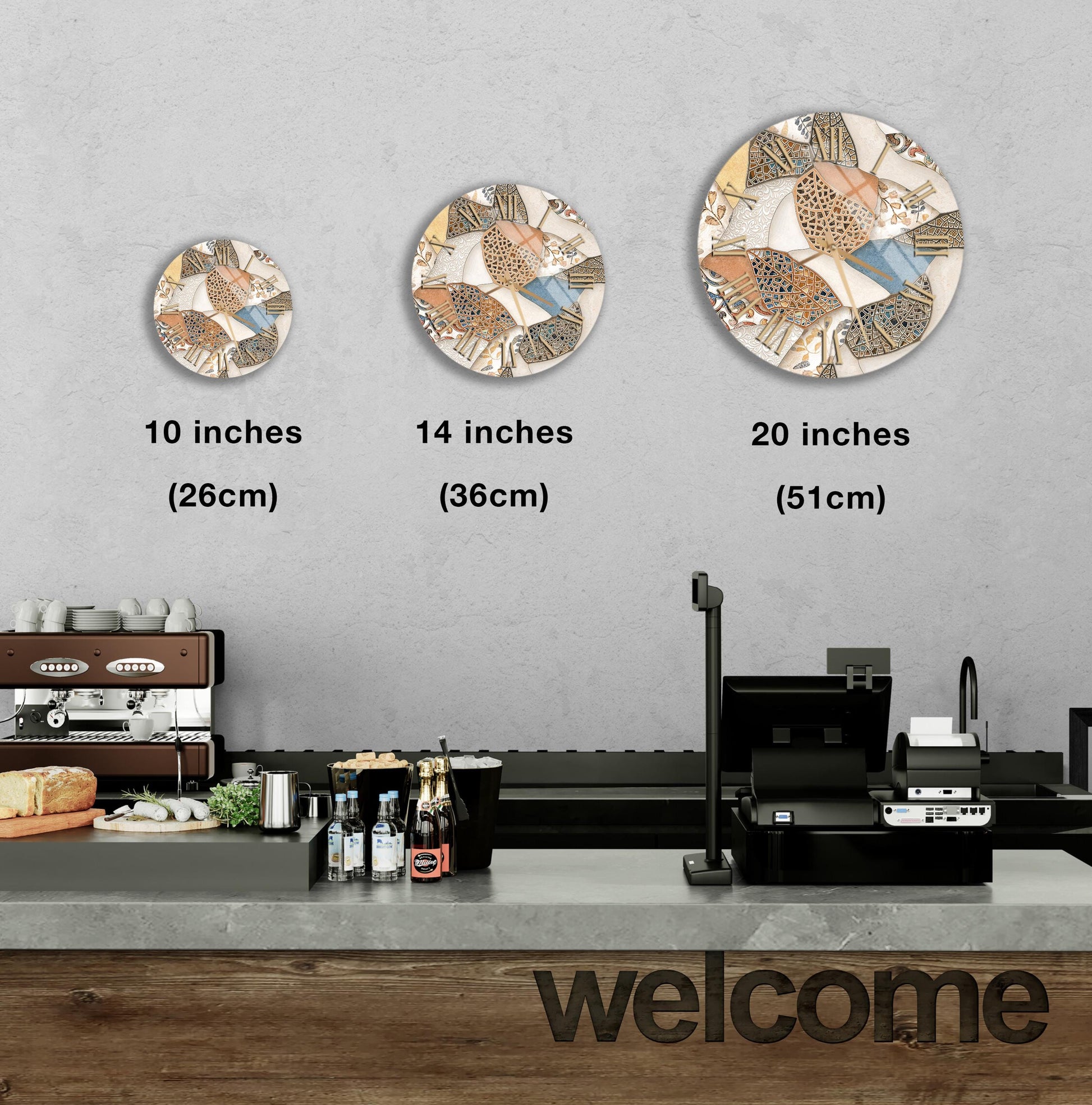 a counter in a restaurant with a "welcome" sign, and three decorative plates of different sizes hanging on the wall above the counter.